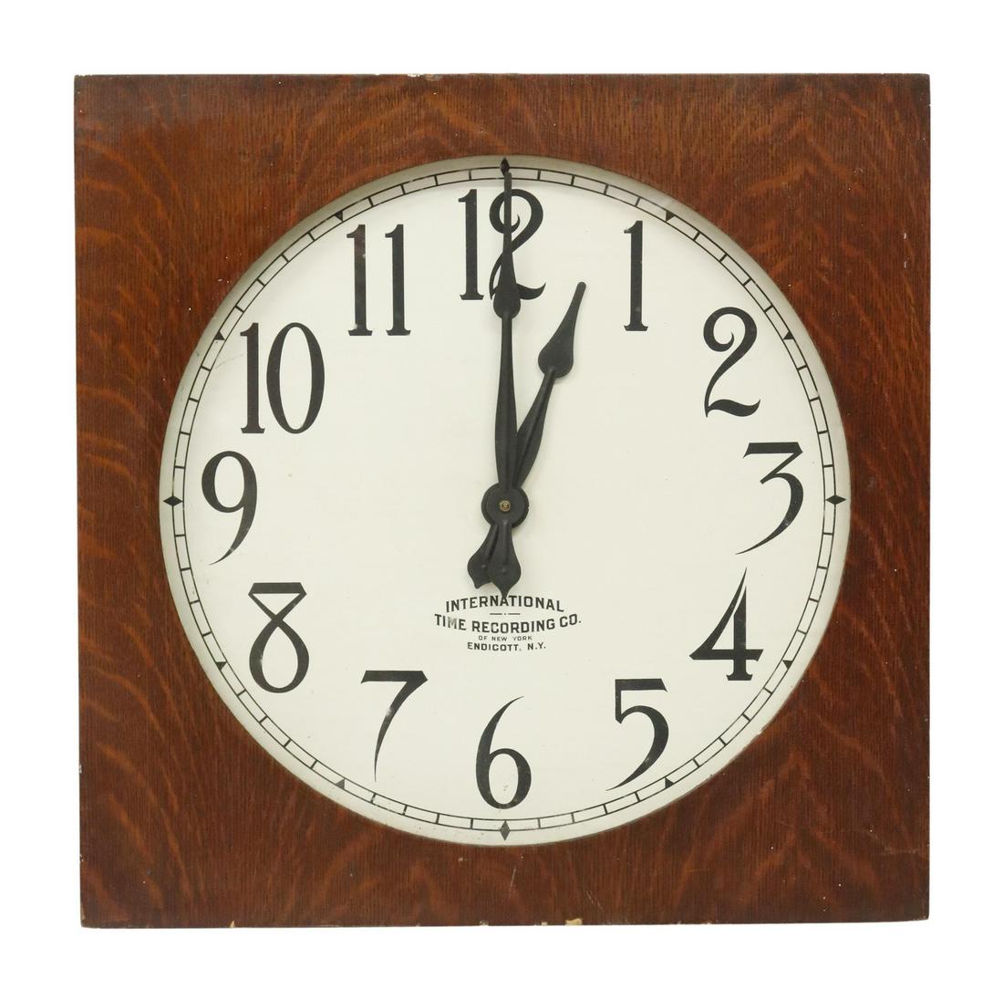 INTL. TIME RECORDING CO. AMERICAN OAK WALL CLOCK: American oak wall clock, International Time Recording Company of New York, Endicott, New York, late 19th/ early 20th c., square oak case, encasing round glazed viewing panel, enameled dial, with black