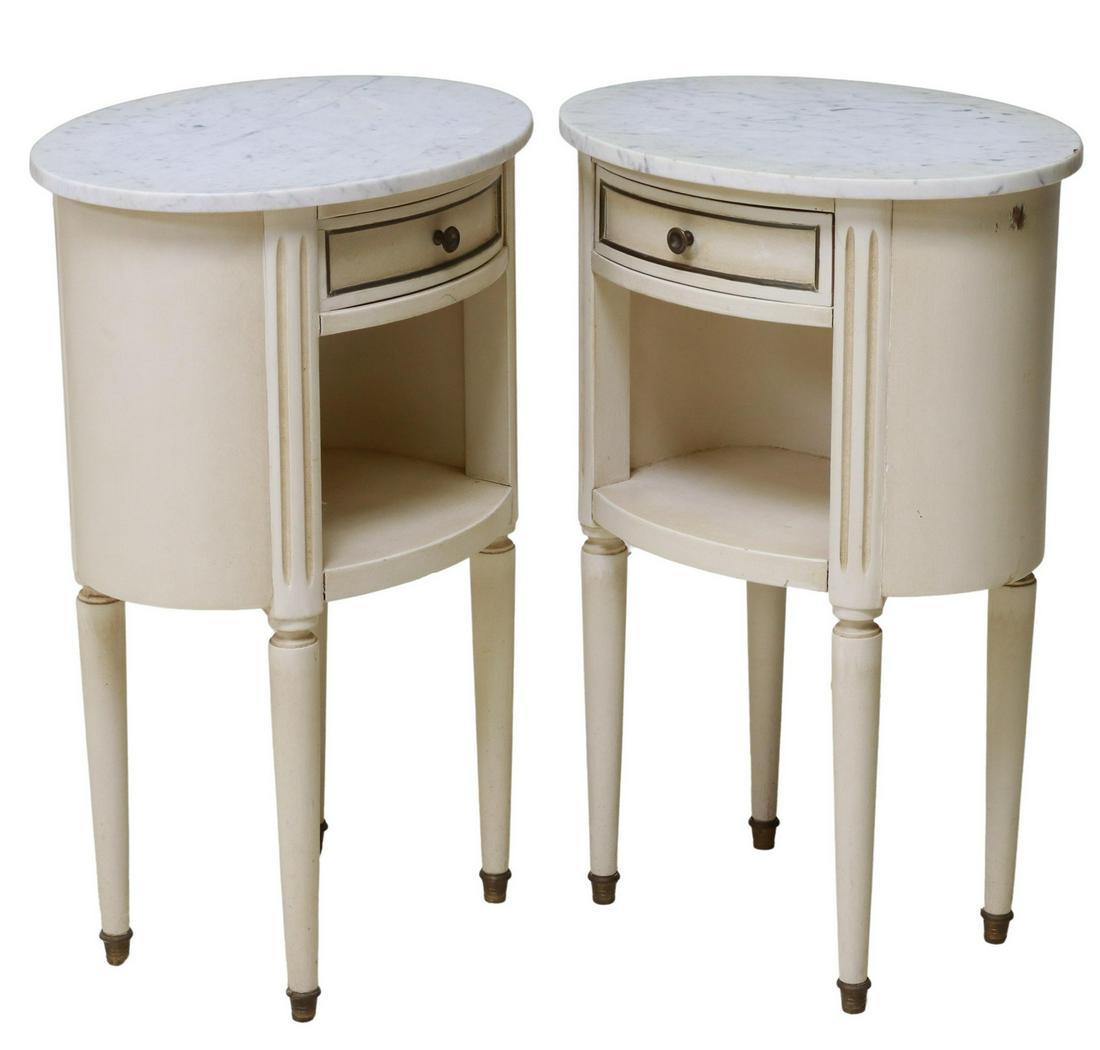 (2) LOUIS XVI STYLE MARBLE-TOP PAINTED NIGHTSTANDS: (pair) Louis XVI style painted wood nightstands, 20th c., having ovular marble top, over single drawer, above open storage, flanked by fluted corner posts, rising on tapered supports, ending in brass 