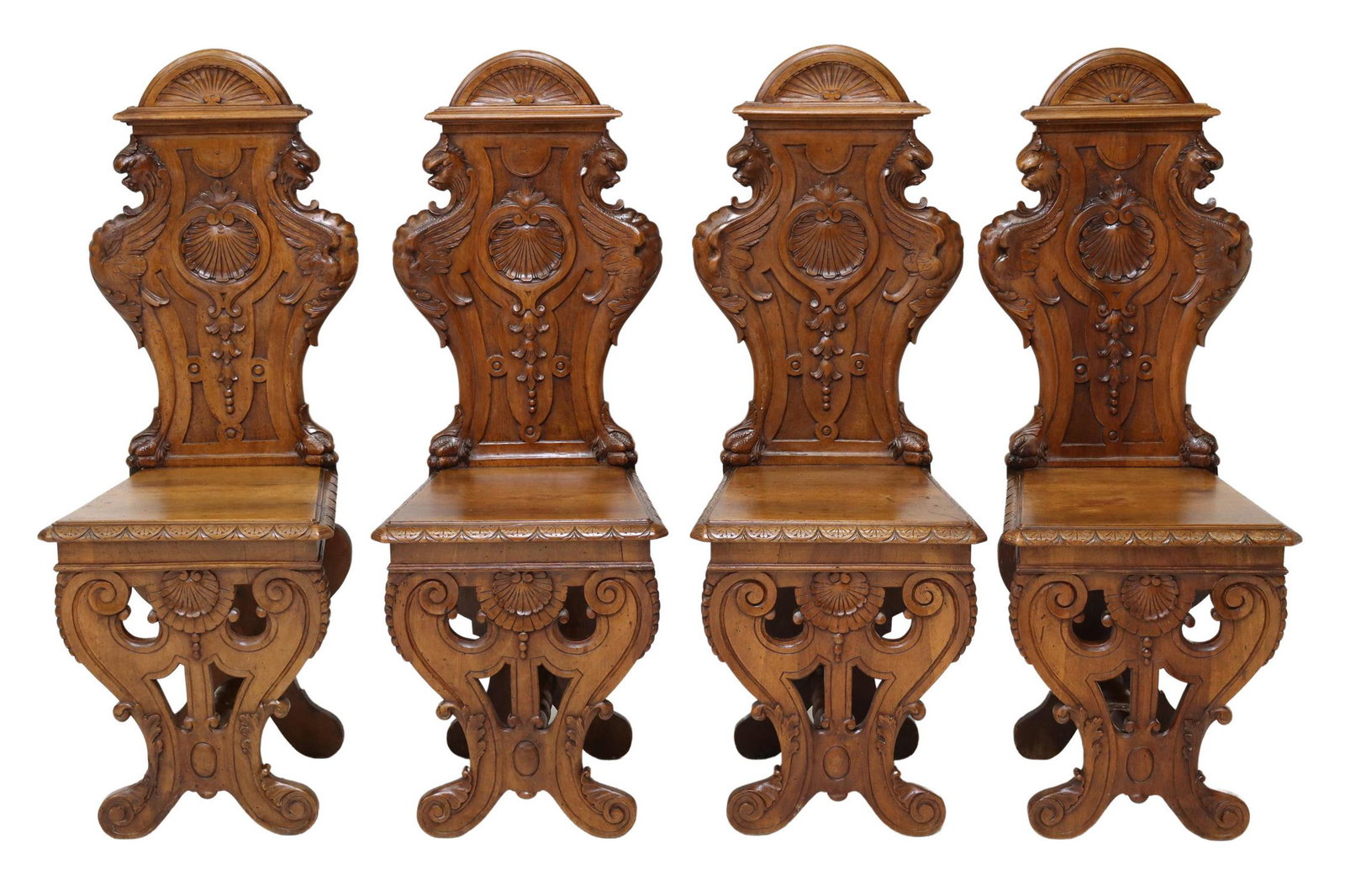 (4) RENAISSANCE REVIVAL CARVED WALNUT HALL CHAIRS: (lot of 4) Italian Renaissance Revival carved walnut hall chairs, late 19th c., having shaped back with central shell motif, flanked by winged griffins, seat with running ornamentation border, rising 