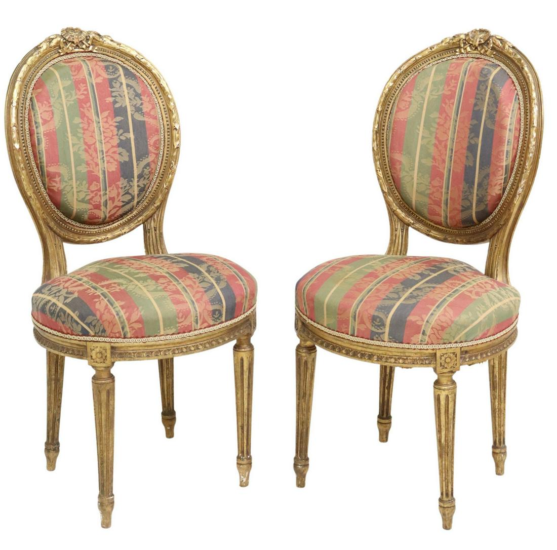 (2) FRENCH LOUIS XVI STYLE GILTWOOD SIDE CHAIRS: (pair) French Louis XVI style giltwood side chairs, 19th c., having ribbon crest, over oval medallion back with foliate molding, striped floral upholstery, ribbon trim, rising on fluted tapered legs, 
