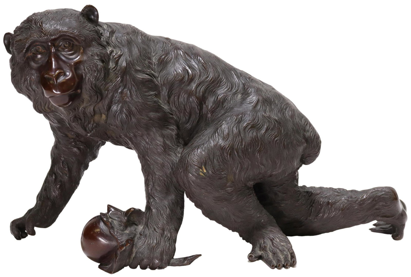 JAPANESE MEIJI-ERA BRONZE OKIMONO MACAQUE MONKEY: Japanese patinated bronze okimono, Macaque Monkey, Genryusai Seiya, Meiji period (1868-1912), naturalistically cast, holding a persimmon in one forepaw, signed in the cast at underside, approx 10.25"h