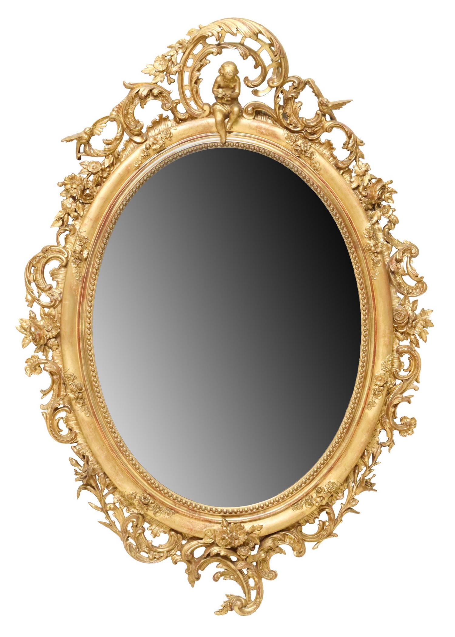 MONUMENTAL FRENCH LOUIS XV STYLE GILTWOOD MIRROR 19th c.: French Louis XV style giltwood wall mirror, 19th c., oval frame surmounted by large foliated rocaille border, having putti and bird crest, over beveled mirror plate, approx 83.5"h, 60.75"w, lbs Start 