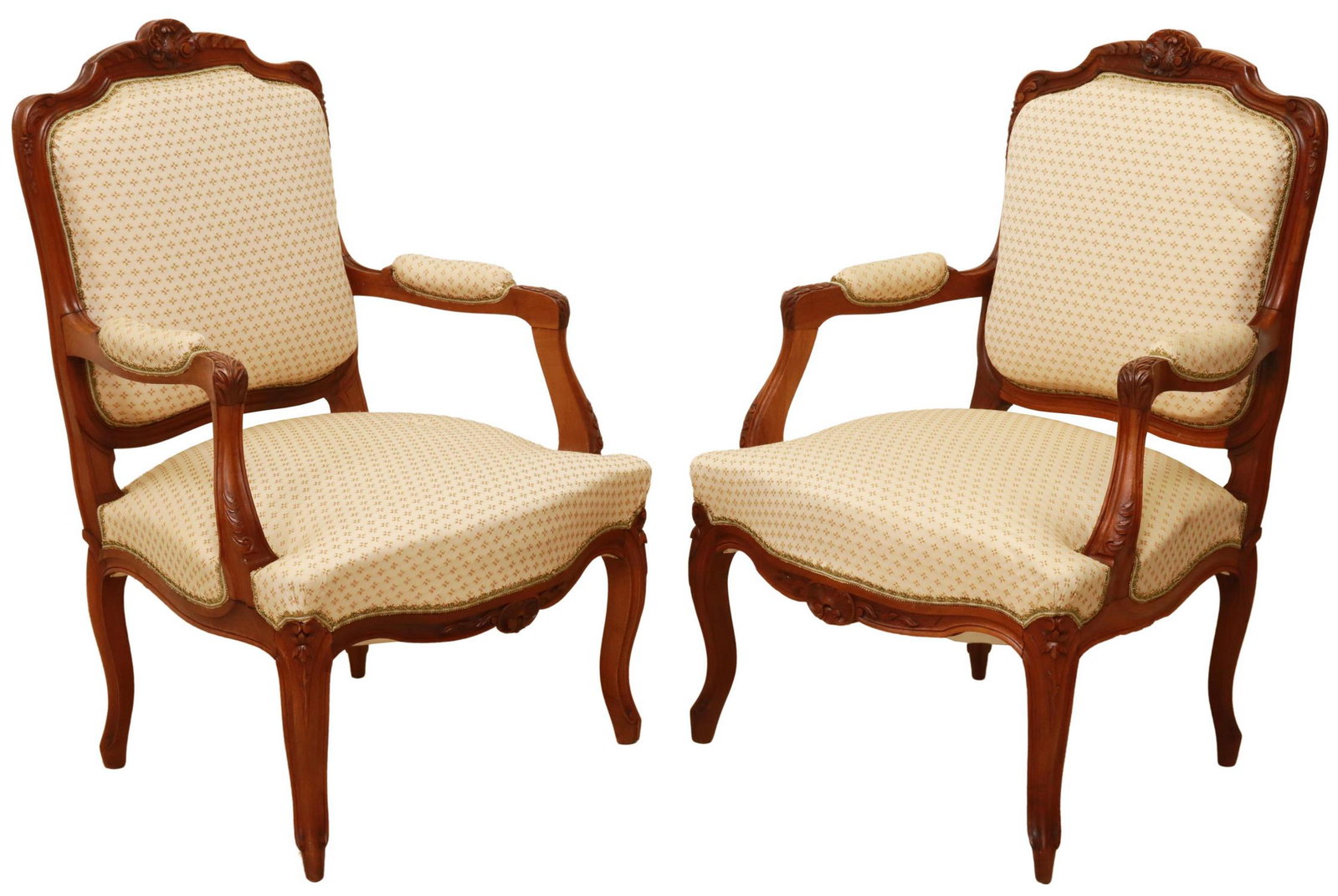 (2) FRENCH LOUIS XV STYLE UPHOLSTERED FAUTEUILS: (pair) French Louis XV style armchairs, 20th c., having carved rocaille crest, in a floral upholstery, with foliate handholds, above shell motif apron, rising on cabriole legs, ending on whorl feet, a