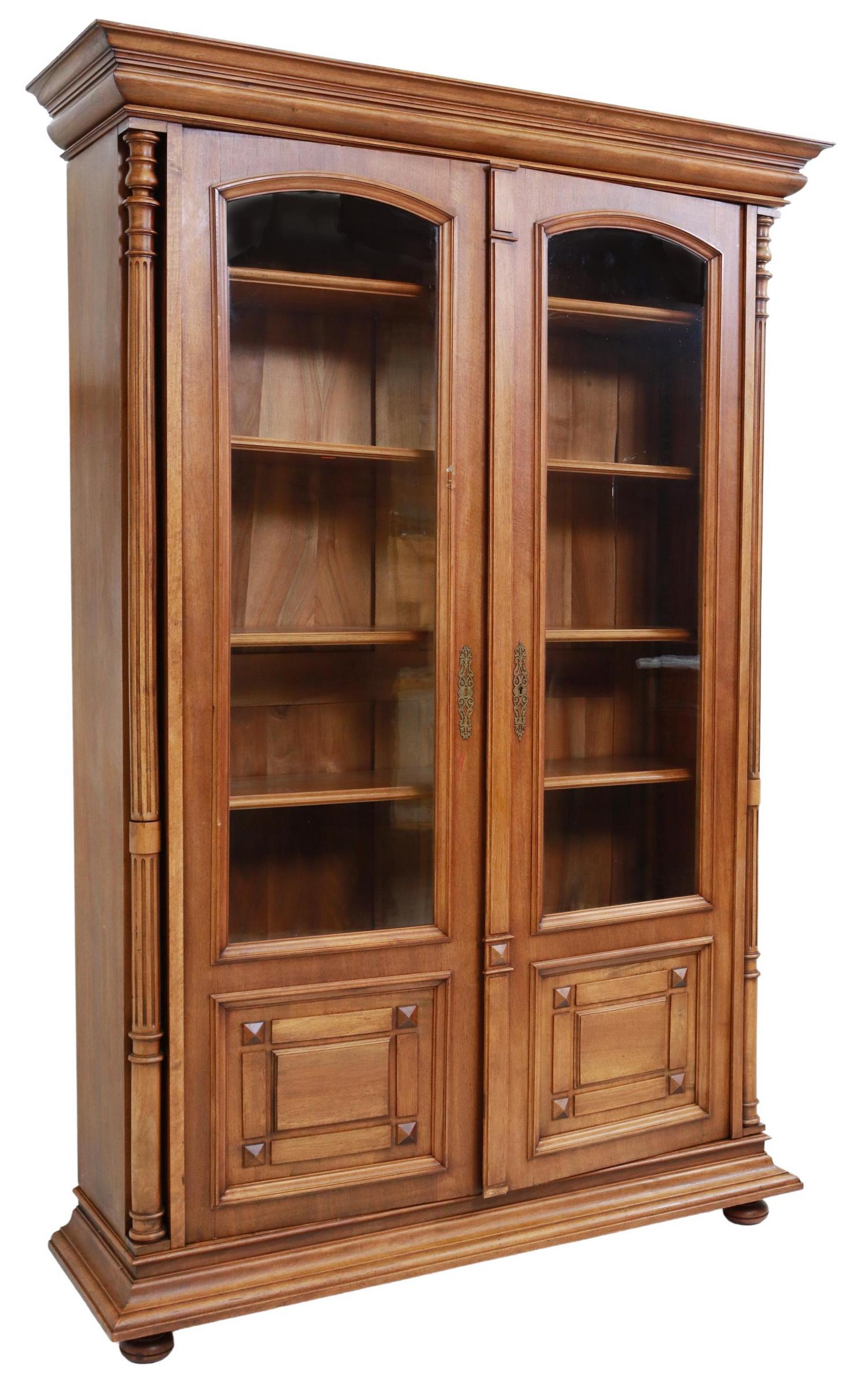 FRENCH LOUIS PHILIPPE PERIOD WALNUT BOOKCASE: French Louis Philippe period walnut bookcase, 19th c., molded cornice, glazed doors framed by turned and fluted columns, adjustable-height shelves, rising on bun feet, approx 84"h, 57"w, 17"d Start Pr