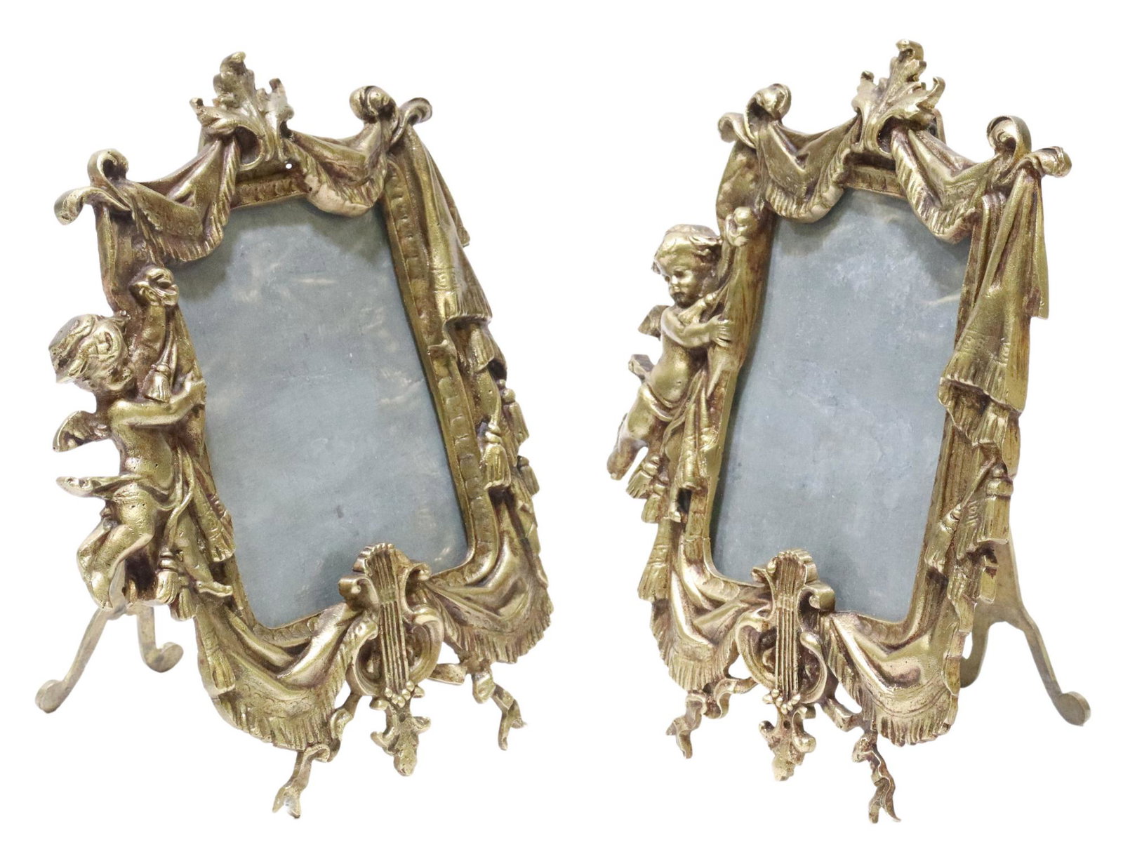 (2) FRENCH BRONZE TABLETOP PICTURE FRAMES: (lot of 2) French bronze tabletop picture frames, winged putto with draped fabric, easel back, sight: approx 4 7/8"h, 3 5/8"w, overall: 9.25"h, 7"w; 3.25lbs total Start Price: $150.00