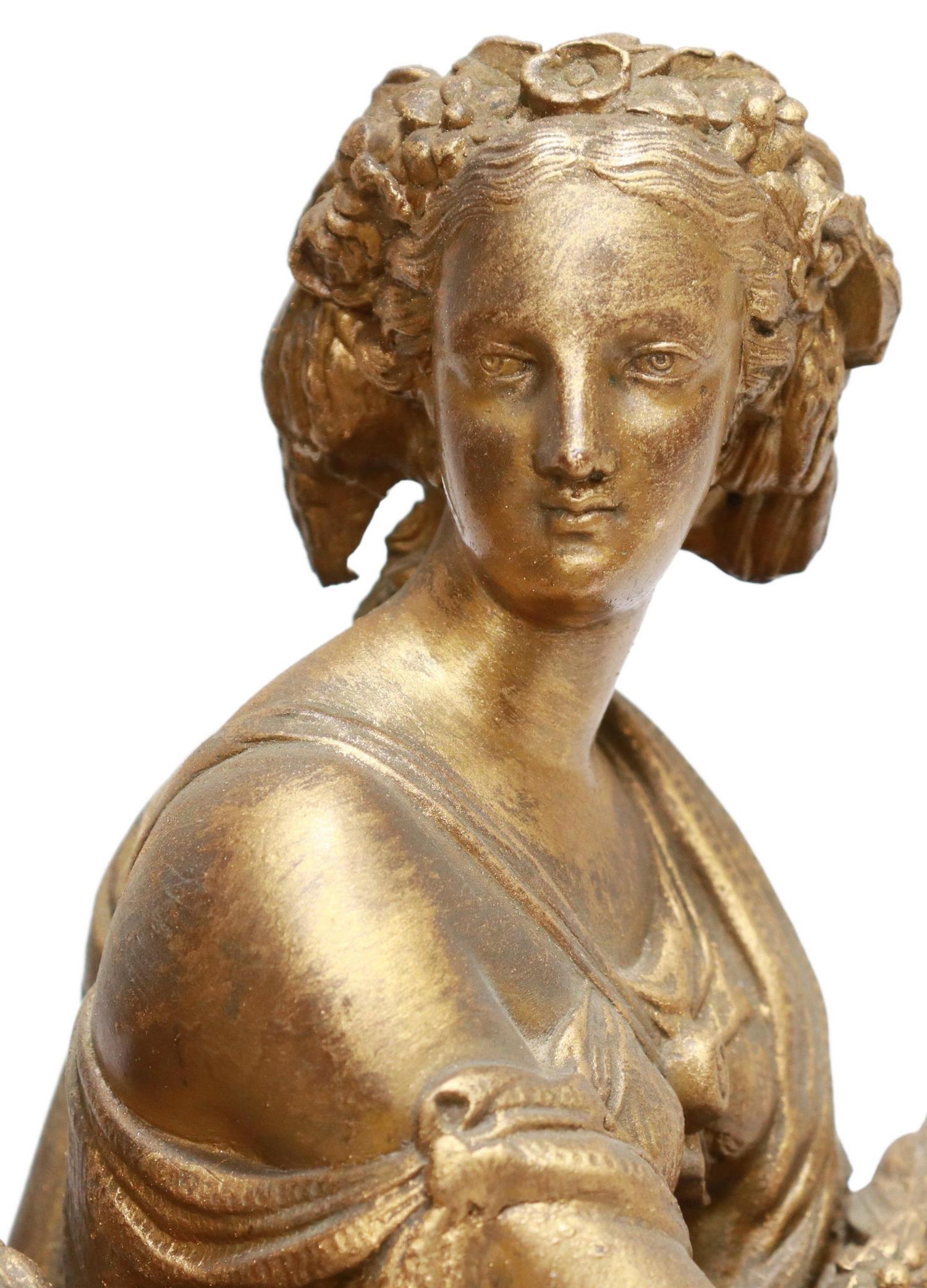 FRENCH GILT METAL FIGURAL MANTEL SHELF CLOCK: French gilt metal mantel shelf clock, late 19th c., seated female figure with scythe and sheaves of wheat, enamel dial with cobalt Roman numeral hour markers, time-and-strike movement stamped S. Marti
