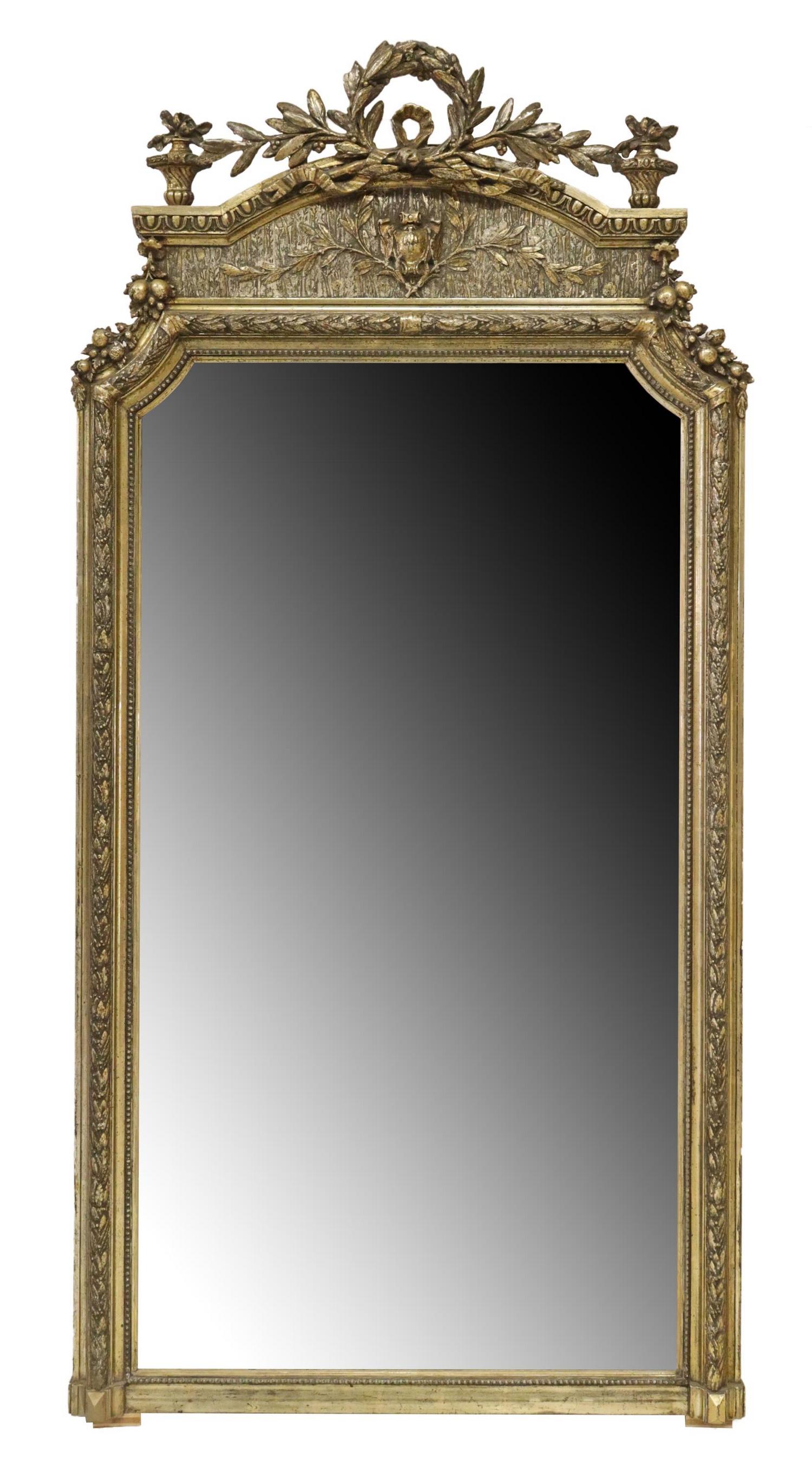 FRENCH LOUIS XVI STYLE GILTWOOD MIRROR: French Louis XVI style giltwood wall mirror, 19th c., having laurel crest, flanked by foliated urn finials, shaped frame encasing flat mirror plate, approx 75.75"h, 38"w, 71.5lbs Start Price: $300.00