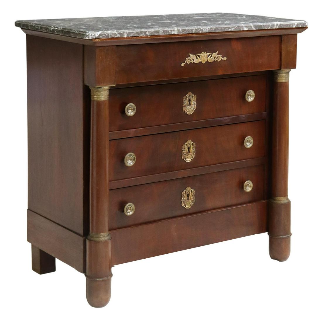 FRENCH EMPIRE STYLE MARBLE-TOP MAHOGANY COMMODE: French Empire style mahogany marble-top commode, 20th c., having frieze drawer, with gilt metal swan mount, over three additional drawers, flanked by turned columnar supports, rising on cup feet, appr