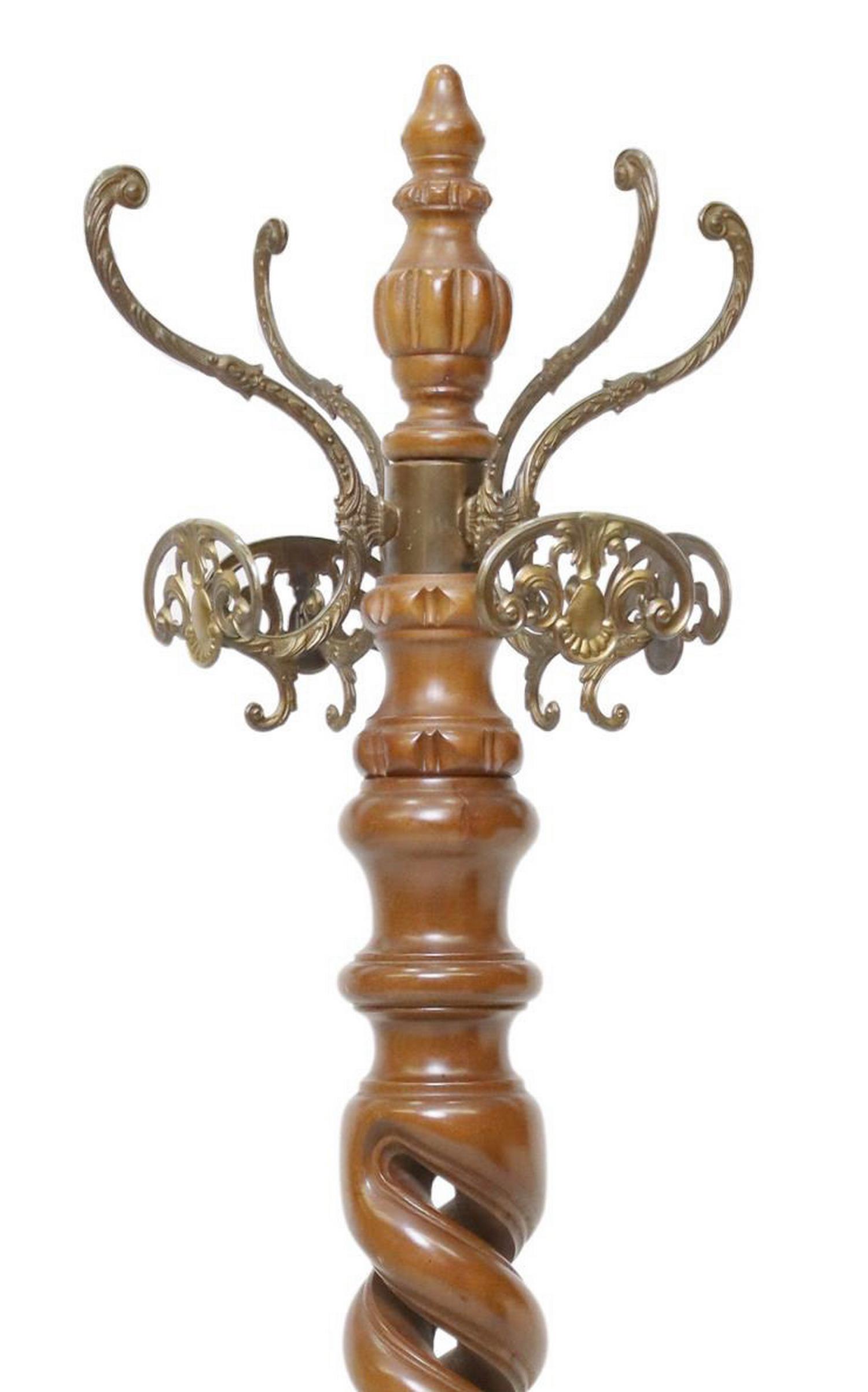 ITALIAN CARVED OAK TWIST STANDARD HALL TREE: Italian carved oak hall tree, 20th c., turned finial issuing four scrolled gilt metal arms, open twist standard, over vasiform base, ending on stepped round platform, approx 69.25"h, 15.5"diam Start P