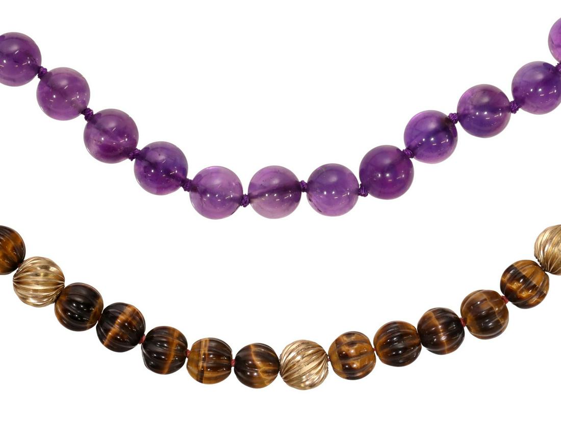(2) ESTATE BEADED TIGERS EYE & AMETHYST NECKLACES: (lot of 2) Estate beaded necklaces: (1) having ribbed tigers eye beads, spaced by gilt metal beads, gilt silver clasp, approx 24"l; (1) amethyst bead necklace, individually knotted, gilt silver clasp,