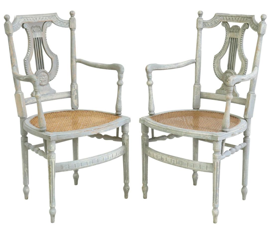 (2) FRENCH LOUIS XVI STYLE LYRE-BACK FAUTEUILS: (lot of 2) French Louis XVI style armchairs, early 20th c., matte painted frame, lyre-form back, cane seat, rising on tapering fluted front legs, approx 38"h, 21.25"w, 19"d, seat height: 18"h Start Pr
