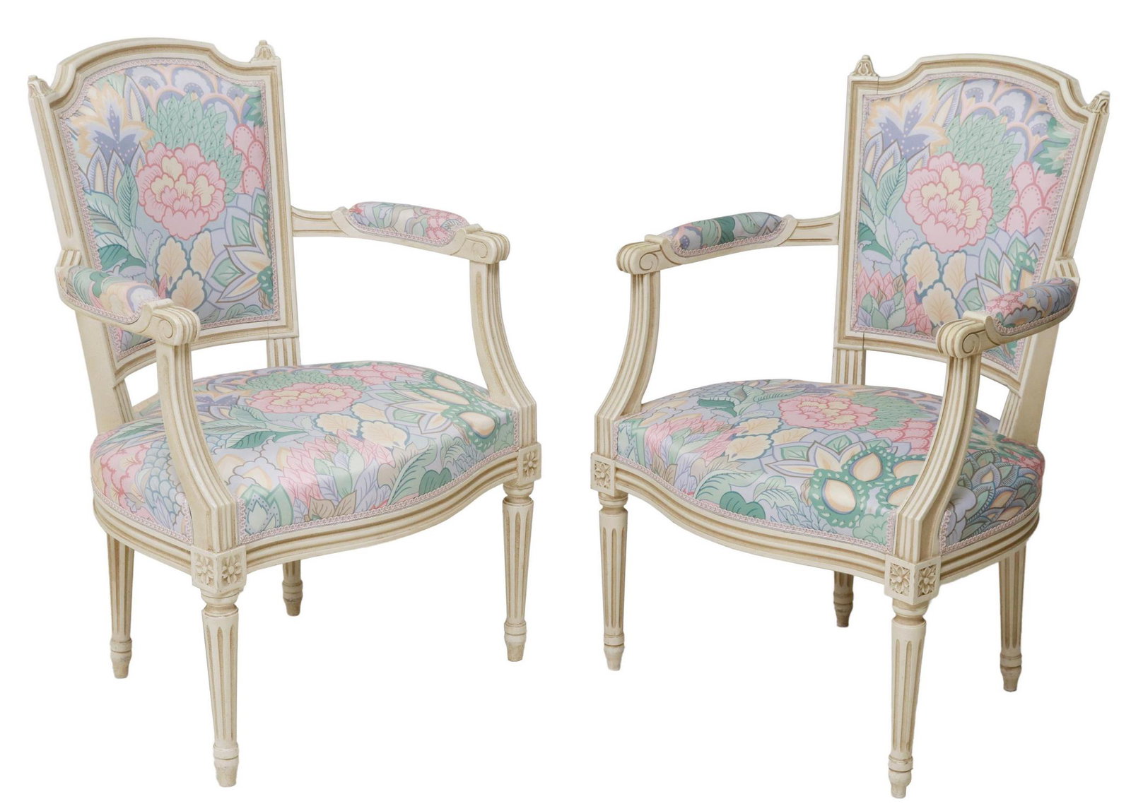 (2) FRENCH LOUIS XVI STYLE UPHOLSTERED FAUTEUILS: (pair) French Louis XVI style armchairs, 20th c., painted frame, with floral upholstery, scrolled handholds, rising on fluted and tapered legs, ending on blunt arrow feet, approx 34.25"h, 23"w, 19"d, 