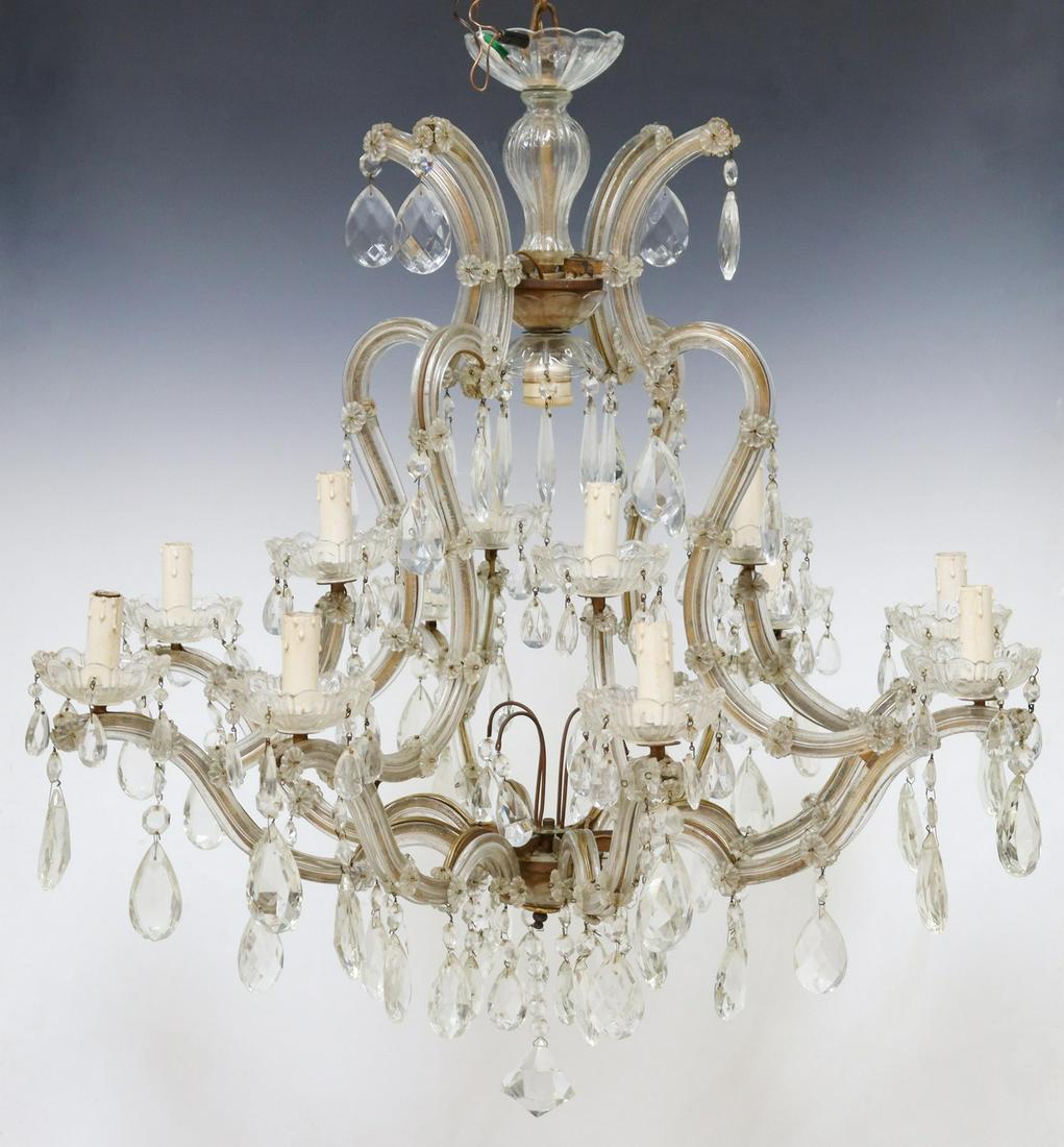 MARIA THERESA STYLE GLASS-CLAD 13-LIGHT CHANDELIER: Maria Theresa style thirteen-light chandelier, late 20th c., having molded glass standard, issuing glass-clad arms, terminating in floral bobeches, hung with prism, all over drop diamond-form prism, i
