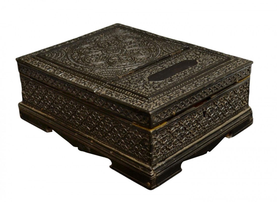 ANTIQUE ANGLO INDIAN CARVED EBONY TRAVEL BOX: Anglo Indian ebony dresser box intricately carved in the Mughal pattern, the hinged articulated top set with an opening to a sandalwood interior fitted with compartments and lift out tray, a beveled r
