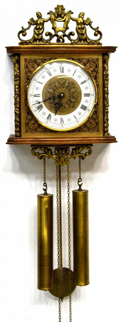 GERMAN TWO WEIGHT WALL CLOCK: German oak cased with foliate decorated metal face and dial, two weight movement, operating, 15.5"h, 10.75"w, 5.5"d, 12.5lbs Start Price: $100.00