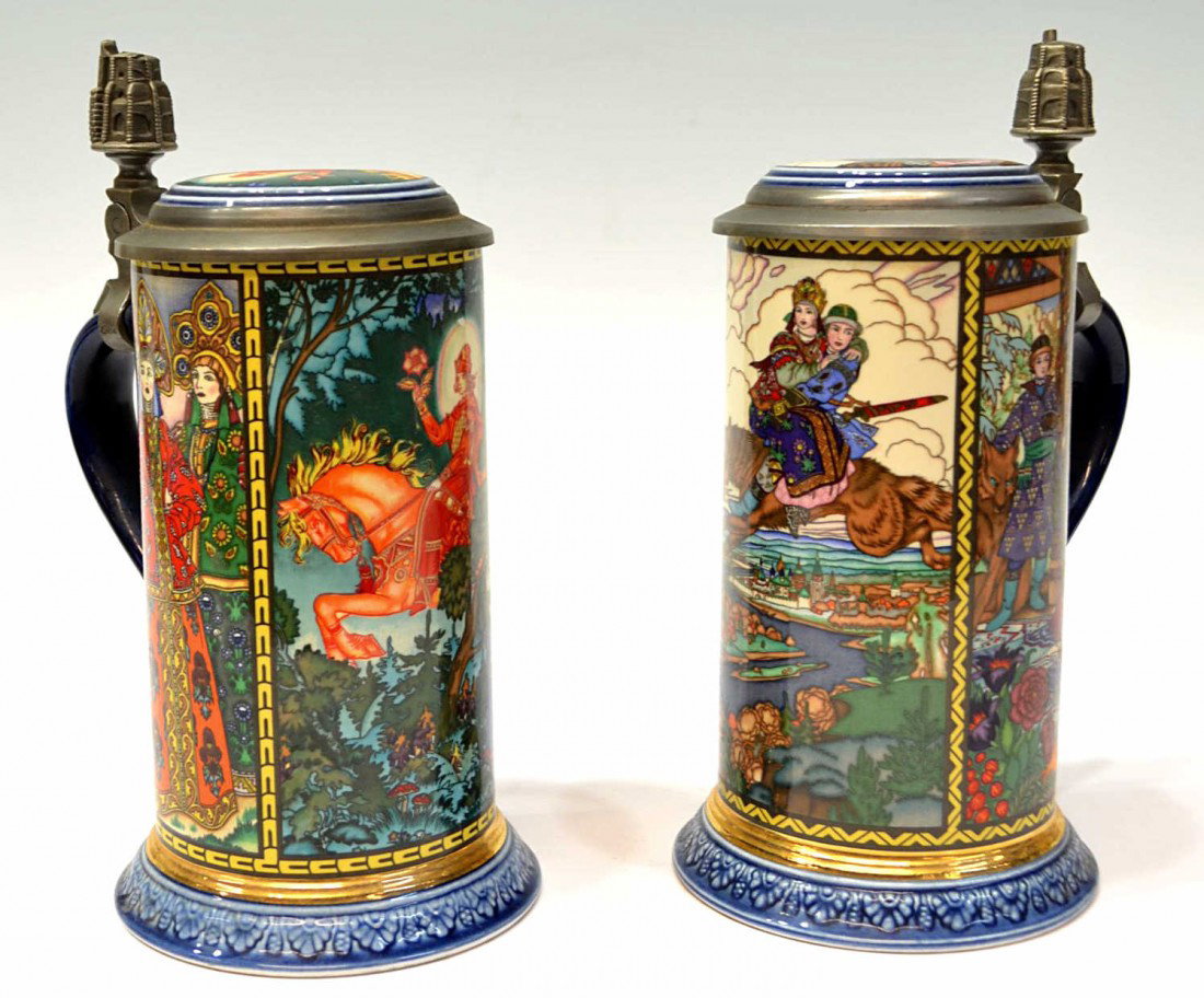 (2) VINTAGE RUSSIAN FAIRY TALE STEINS: (lot of 2) 'Russian Fairy Tales' parcel gilt porcelain steins, impressed Villeroy and Boch Mettlach castle mark, Viking Inc.: (1) numbered 1528 with scenes of a royal wedding, Ivan on the Grey Wolf, a