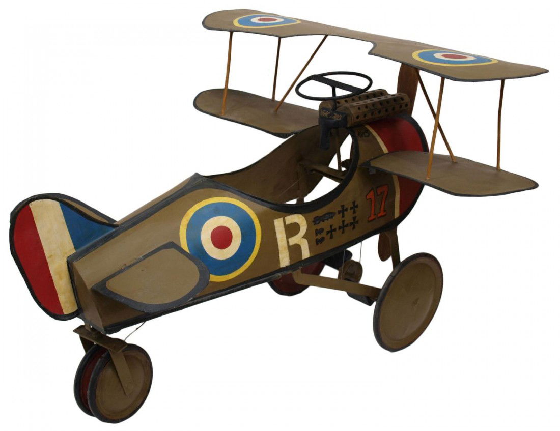 CHILD'S POLYCHROME WWI BIPLANE PEDAL CAR REPLICA: Child's pedal car, a replica of a WWI biplane, polychrome paint decoration on the body set with a wooden propeller that spins as car is peddled, approx. 29"h, 43.75"l, 38.5"w Start Price: $400.00