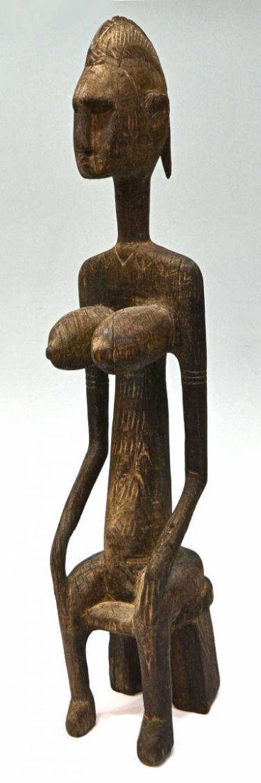 LARGE AFRICAN BAMBARA STATUE, FERTILITY FIGURE: African carved wood figure, Bambara ethnic group, Mali, early 20th c., a seated female figure with narrow elongated head, enlarged breasts indicating fertility, incised carving at back, 33"h, 6"w, 7.7