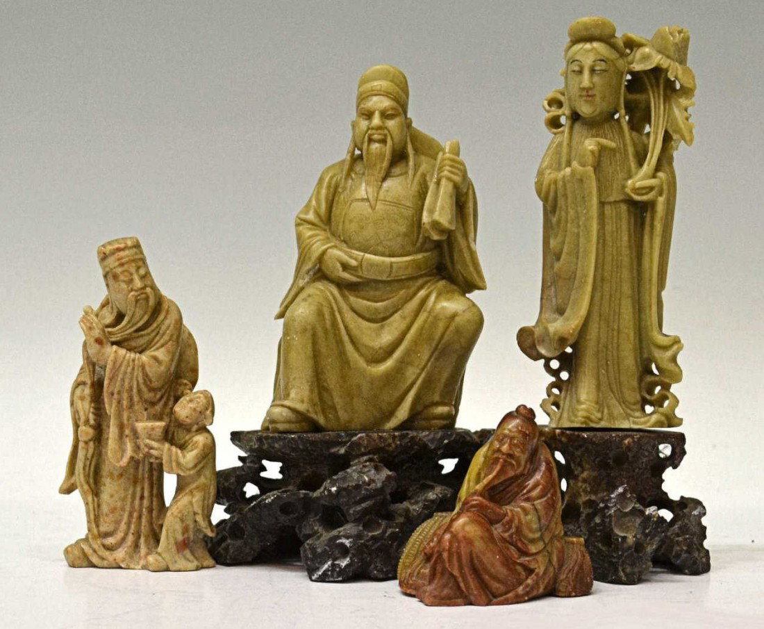 GROUP OF CHINESE CARVED SOAPSTONE FIGURES: (lot of 4) Chinese soapstone figural carvings, including: (1) maiden holding a large flower on a pedestal, some loss to florets; (1) a seated scholar holding scrolls, incised details of mountains and 