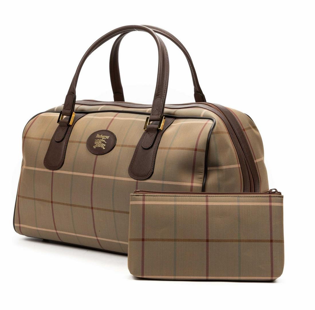BURBERRY 'BOSTON' PLAID CANVAS TRAVEL BAG: Burberry "Boston" travel bag, in plaid canvas, with gold-tone hardware, brown leather trim, dual rolled handles, top zip closure, opening to brown leather lining, single interior zip pocket, retaining