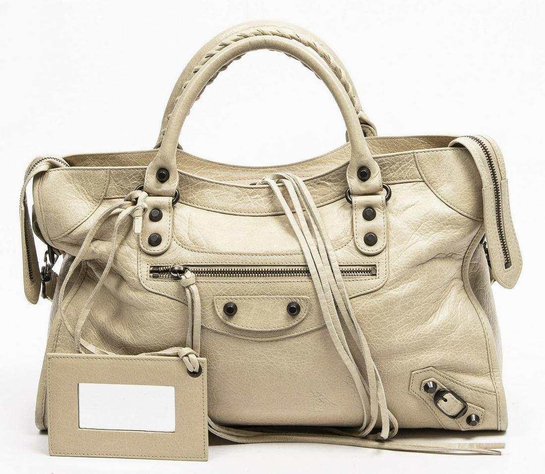 BALENCIAGA 'CITY' IVORY LEATHER SHOULDER BAG: Balenciaga "City" shoulder bag, in ivory distressed leather, with aged brass hardware, dual rolled handles with whipstitch detailing, flat shoulder strap, single exterior zip pocket, top zip closure w