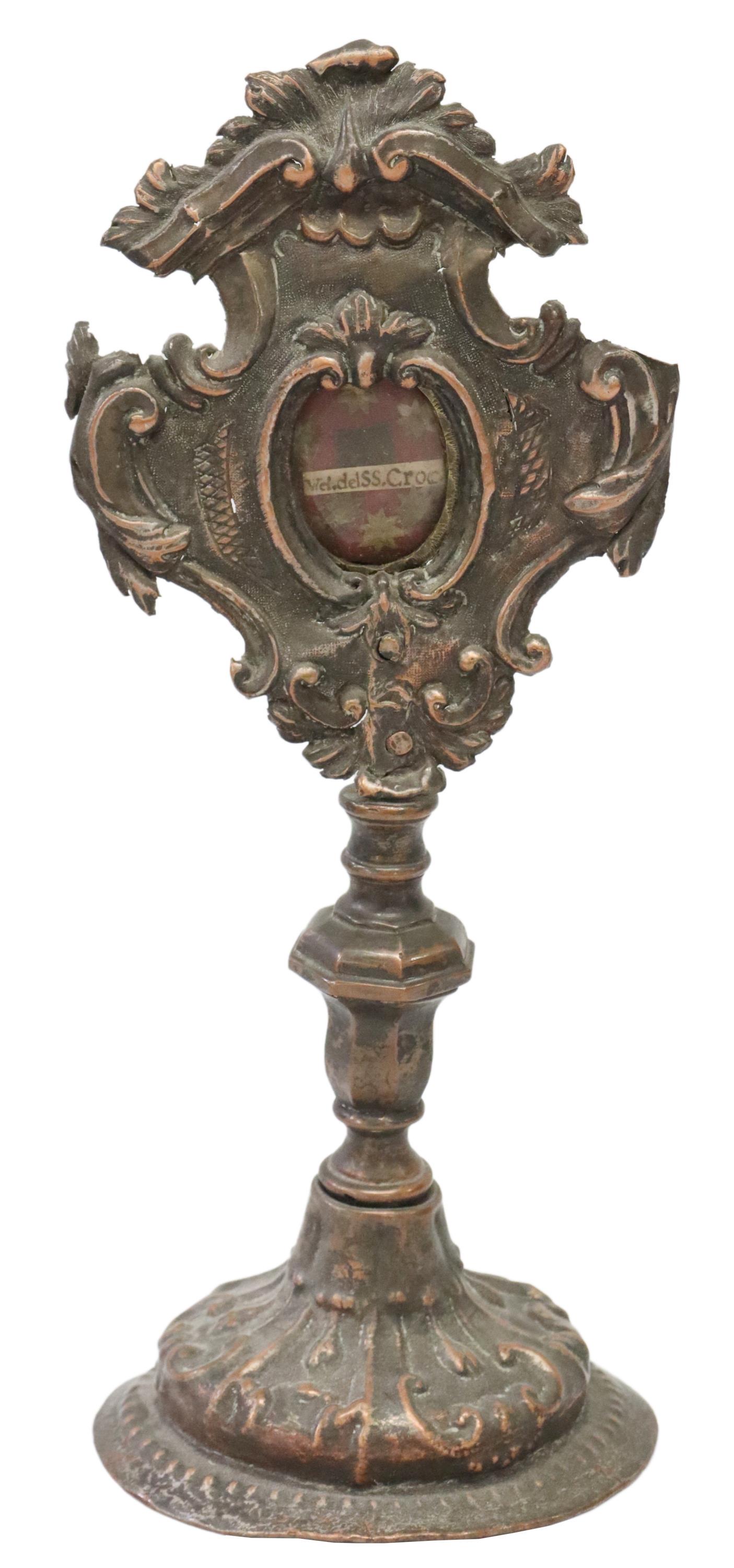 COPPER-TONE METAL ALTAR RELIQUARY WITH HOLY RELIC: Altar reliquary, repousse copper-tone metal, aperture with relic labeled "Vel. del SS Croc.," baluster-form standard, on a domed foot, approx 10"h, 4"diam, 0.5lbs (for shipping purposes only) **Proven