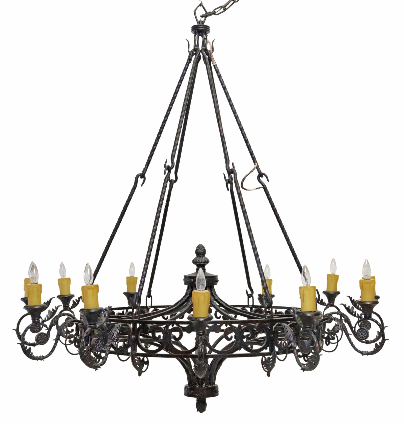 MONUMENTAL WROUGHT IRON TWELVE-LIGHT CHANDELIER: Monumental wrought iron twelve-light chandelier, 21st c., twist hook arms supporting the central ring, issuing foliate scroll arms, ending in faux candles, in need of wiring, (one) arm with stripped t