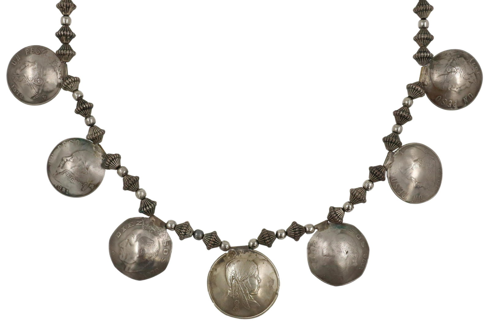SOUTHWEST SILVER BIEN MUR & PESO COIN NECKLACE: Southwest silver (content unknown) necklace, patterned saucer-shaped beads, center one-dollar coin from the Bien Mur Indian Market Center, Pueblo of Sandia, framed by Mexican ten and one peso coins wi
