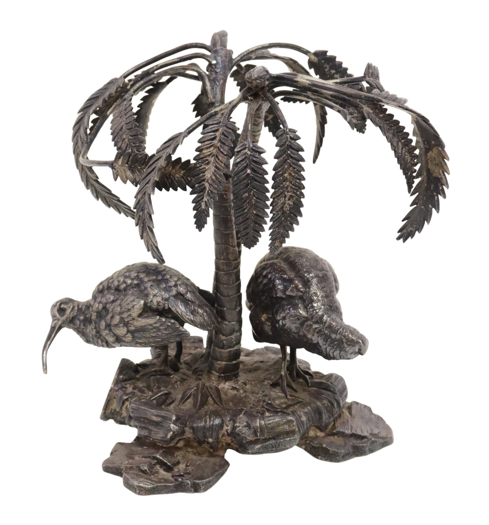ELKINGTON SILVERPLATE CENTERPIECE BIRDS & PALMS: English silverplate centerpiece/ garniture, Elkington & Company, late 19th c., two birds below palm trees, on a naturalistic rocky outcropping, monogrammed BBH, heavily tarnished, approx 7.5"h, 6"w, 6