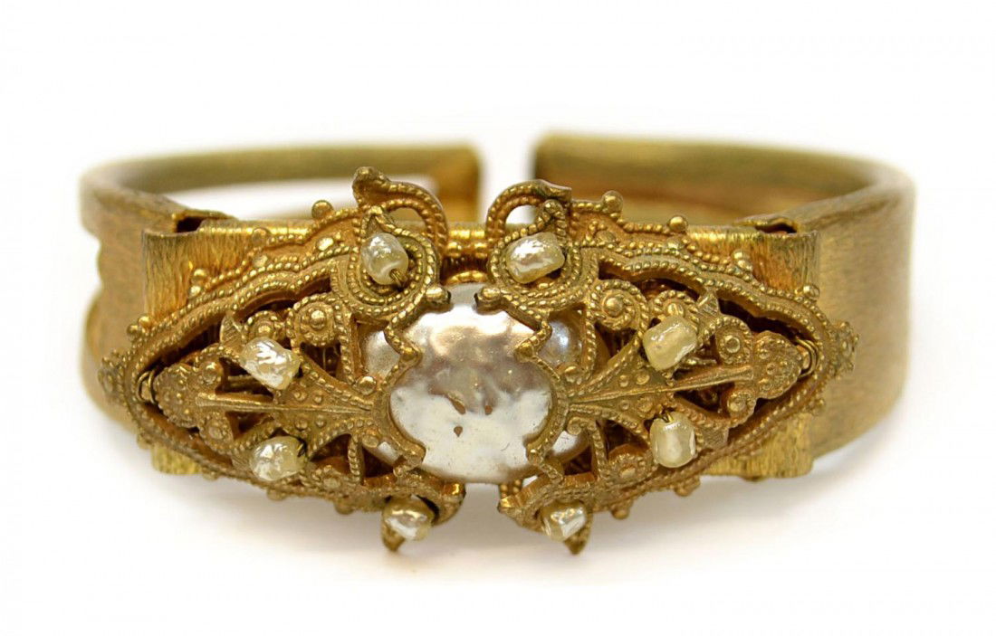 SCARCE VINTAGE MIRIAM HASKELL FAUX PEARL BRACELET: Vintage Miriam Haskell hinged bracelet, gilt metal frame with faux baroque pearl settings, signed in oval plate, approx 2.25"w Start Price: $60.00