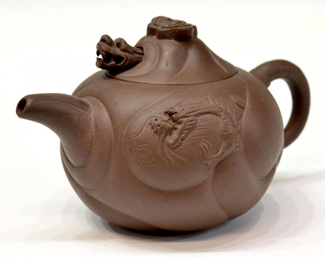 CHINESE YIXING TEA POT, DRAGON: Chinese Yixing, Jiangsu, clay tea pot, 20th c., a dragon at the lid likely whistles, dragon decoration at sides, Chinese characters under lid, 6.5"h, 3.75"w, 4.25"d, 1lb Start Price: $150.00