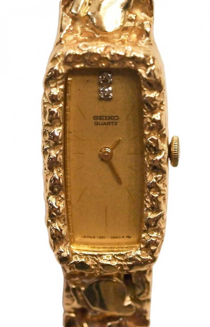 VINTAGE SEIKO 14KT GOLD NUGGET & DIAMOND WATCH: Vintage ladies Seiko Quartz 14kt gold nugget watch, the rectangular dial set with two diamond chips, face marked 'Seiko Base metal top and numbered verso, band stamped 14kt, approx 6.5"l, 43.68 grams 