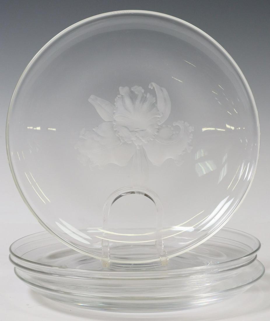 (4) STEUBEN COLORLESS ART GLASS LUNCHEON PLATES: (lot of 4) Steuben colorless art glass luncheon plates, 20th c., one with etched floral motif at center, all bearing engraved signature Steuben underfoot, one with scratch at center, 8.25"diam, 8lbs t