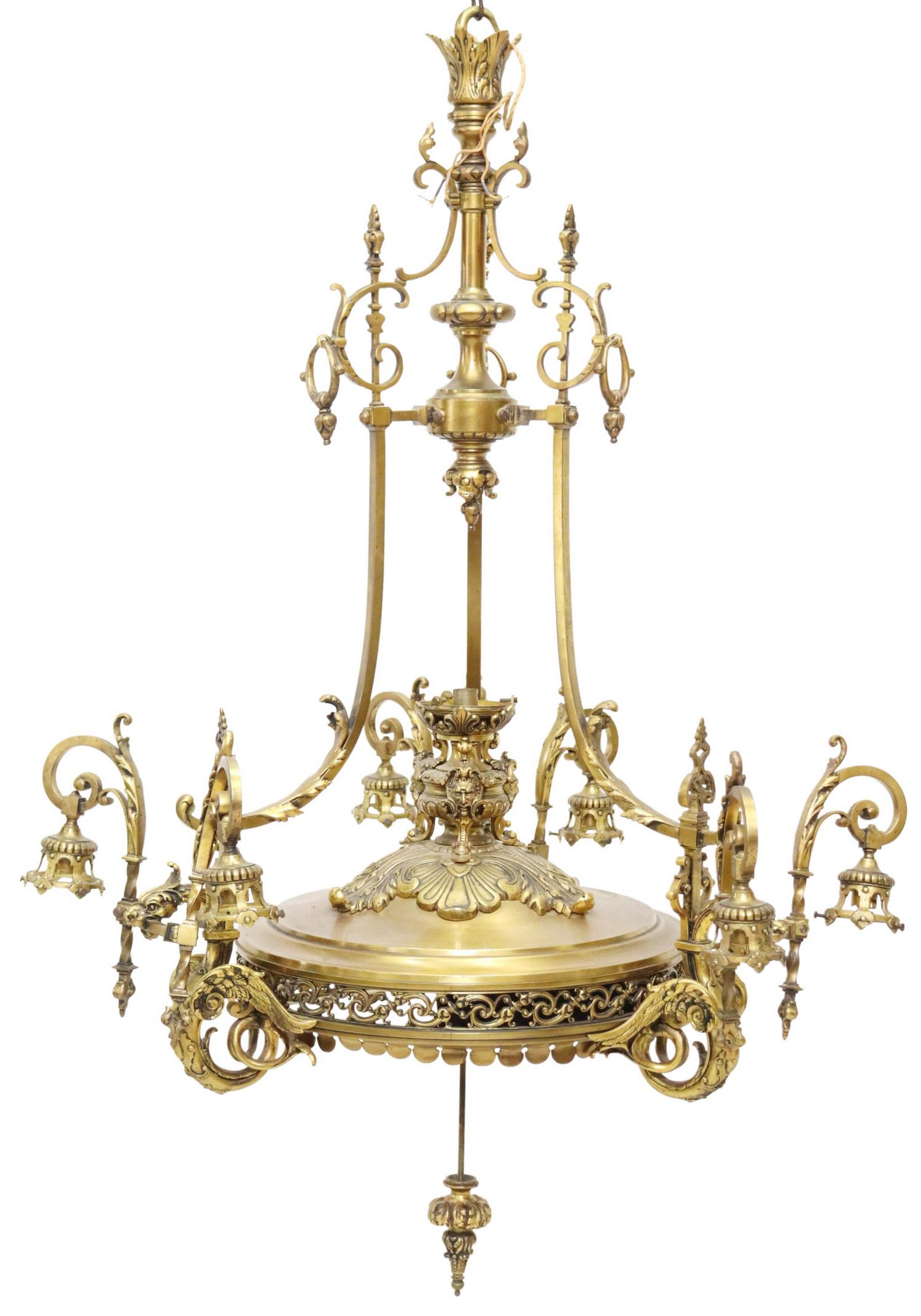 FIGURAL DRAGON GILT-METAL TEN-LIGHT CHANDELIER: Figural gilt metal ten-light chandelier, 20th c., having turned-form standard, over central light encased in urn-form bobeche faced with grotesque masks, pierced gilt-metal top surmounted with dragon 