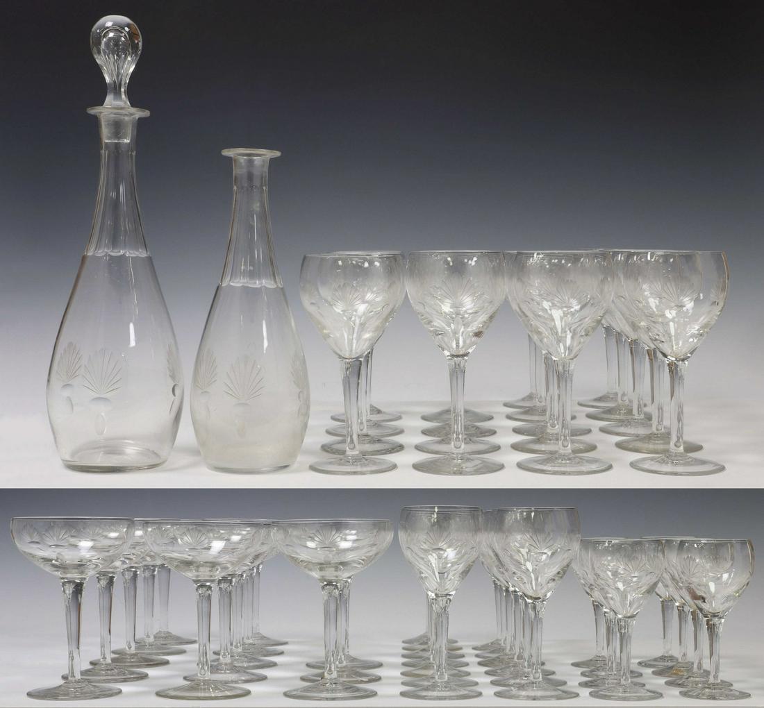 (54) COLORLESS ETCHED CRYSTAL STEMWARE & BARWARE: (lot of 54) Colorless etched crystal stemware and barware, 20th c., each with fan and geometric motifs, including: (18) wine stems, approx 7"h, 3.25"diam; (13) champagne coupes, approx 5.5"h, 3.5"diam