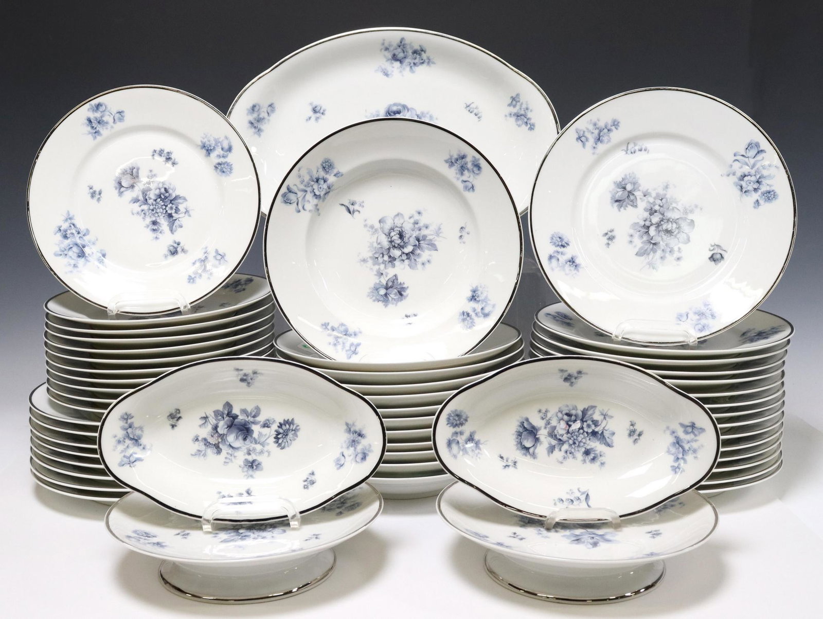 (52) PAUL PASTAUD LIMOGES PORCELAIN DINNER SERVICE: (lot of 52) French Limoges porcelain dinner service, Paul Pastaud, in a blue transfer-printed floral design, including: (23) dinner plates, three with small chips to rim, approx 9 5/8"diam, (11) salad