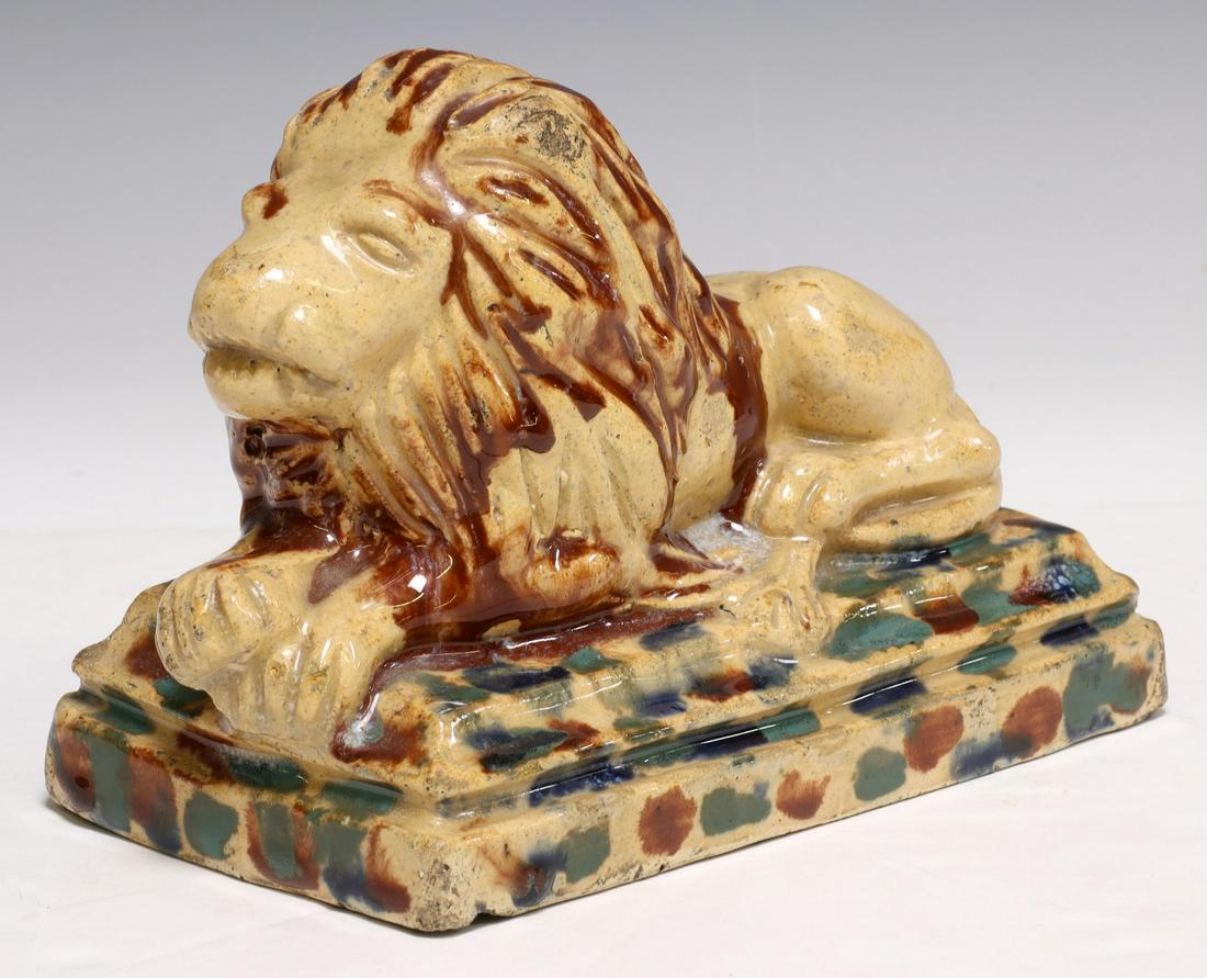 BRITISH POTTERY RECUMBENT LION GARNITURE: British pottery garniture modeled as a recumbent lion, 19th c., accented with mottled blue and brown glazes, approx 5.5"h, 7.75"w, 4.25"d, 3.5lbs Start Price: $150.00