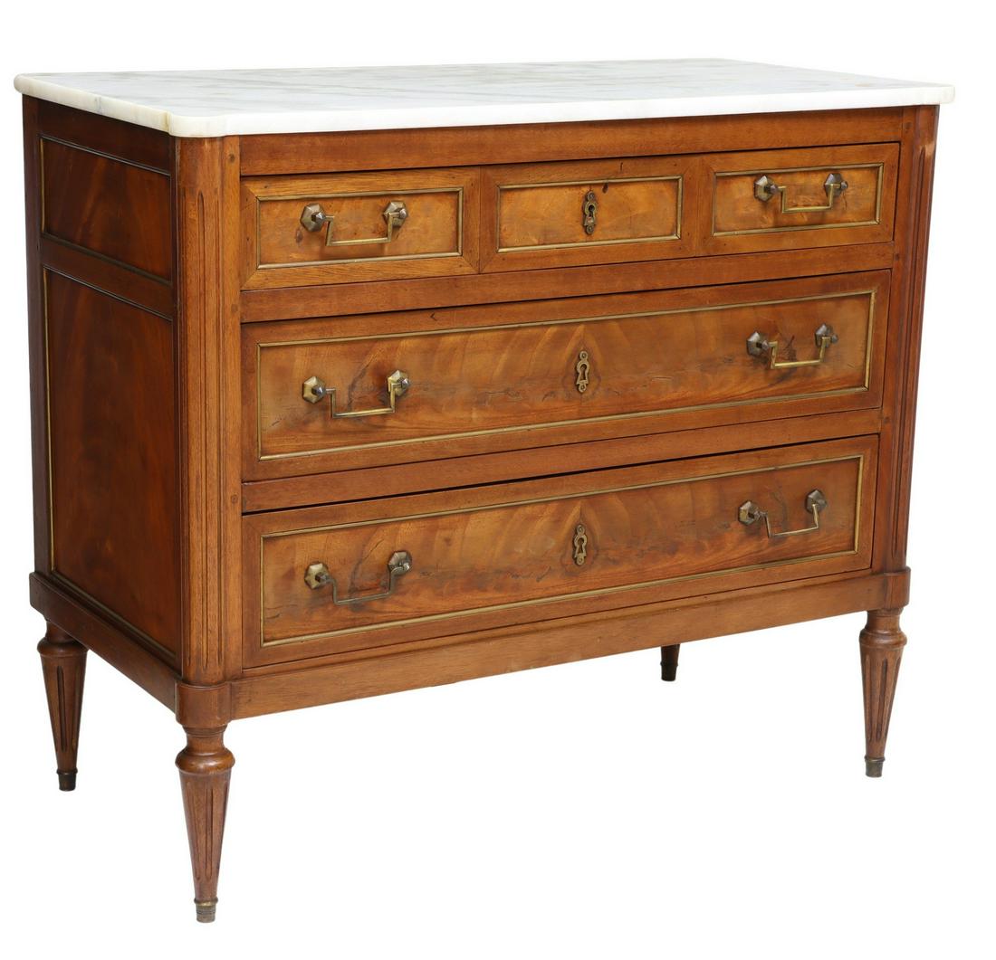 FRENCH LOUIS XVI STYLE MARBLE-TOP MAHOGANY COMMODE: French Louis XVI style marble-top mahogany commode, early 20th c., three drawers flanked by fluted corner posts, rising on tapered legs, approx 32.25"h, 37"w, 18.25"d Start Price: $400.00