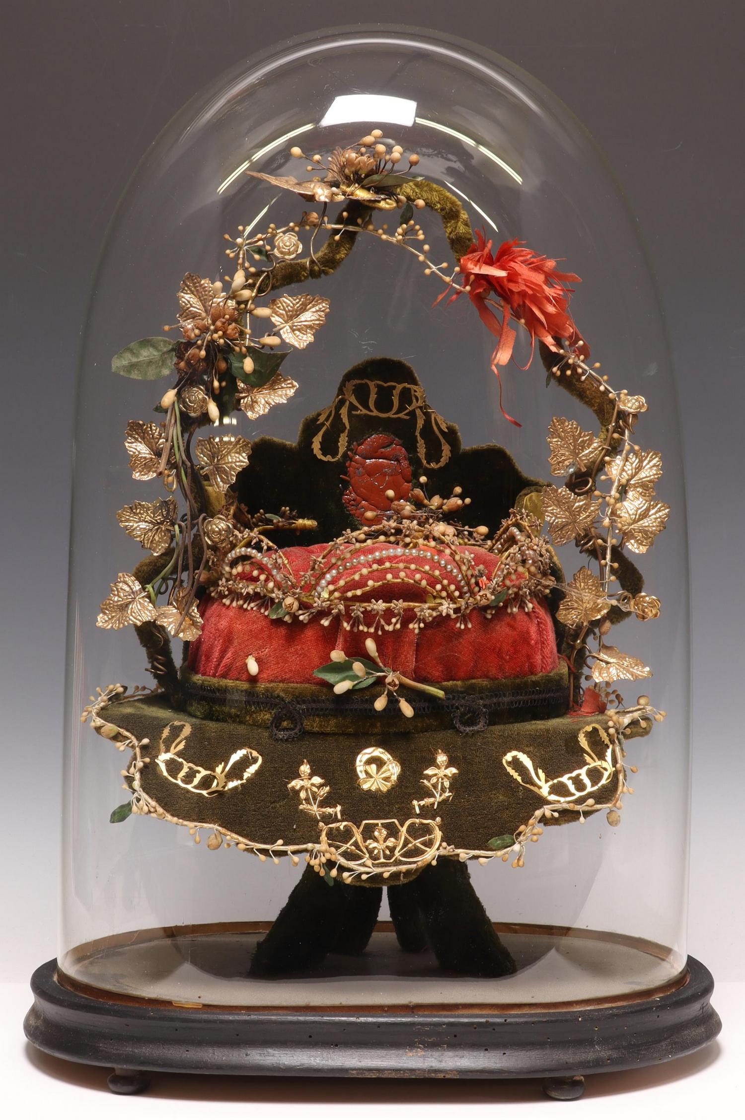FRENCH GLOBE DE MARIEE GLASS CLOCHE GARNITURE: French globe de mariee/ bride's globe, late 19th c., glass cloche/ dome on ebonized base, enclosing gilt metal and fabric-clad frame with silk flowers, tufted cushion, overall: approx 19.75"h, 13.5"w,