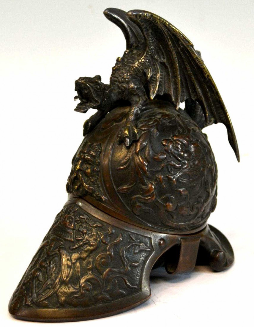 ANTIQUE BRONZE HELMET FORM GRIFFIN INKWELL: Bronze helmet form inkwell, British, 19th c., in the style of a Roman ceremonial helmet of the1st-3rd centuries, a winged griffin/dragon surmounting the hinged helmet, with makers mark as pictured, re