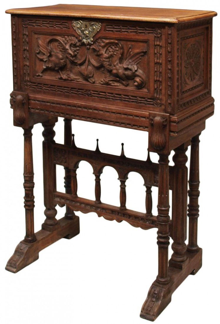 ANTIQUE SPANISH VARGUENO CABINET ON STAND: Spanish Renaissance style walnut vargueno on stand, 19th c., the rectangular case drop front with ornamental carving of winged griffins and a large lock plate, opening on shell carved slides to reveal