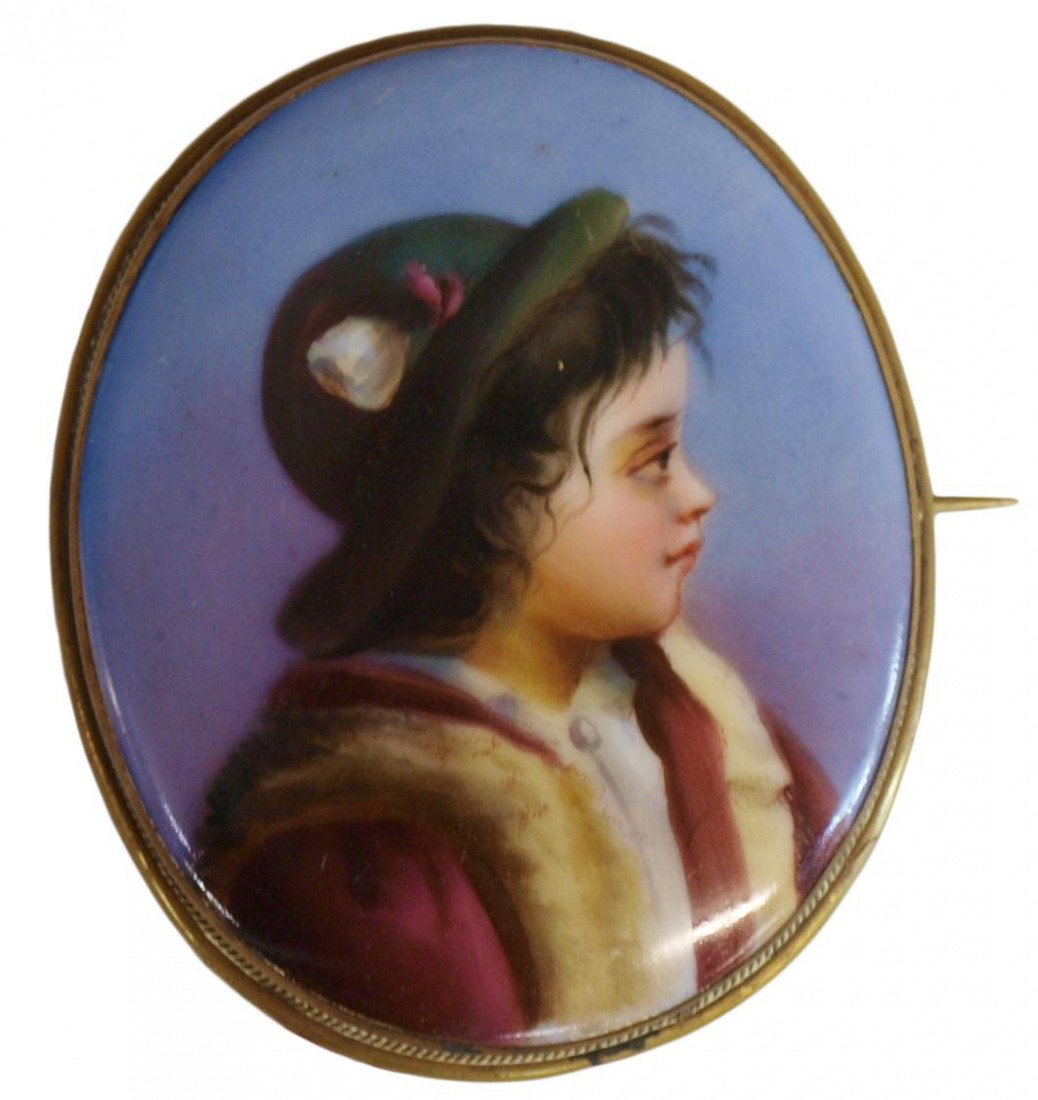 FRAMED CONTINENTAL PORTRAIT BROOCH OF A CHILD: A Continental hand painted porcelain brooch, the profile portrait of a child, framed under glass, brooch: 2.5"h, 21/8"w, framed: 7.5"h, 7.5"w, .75lbs Start Price: $50.00