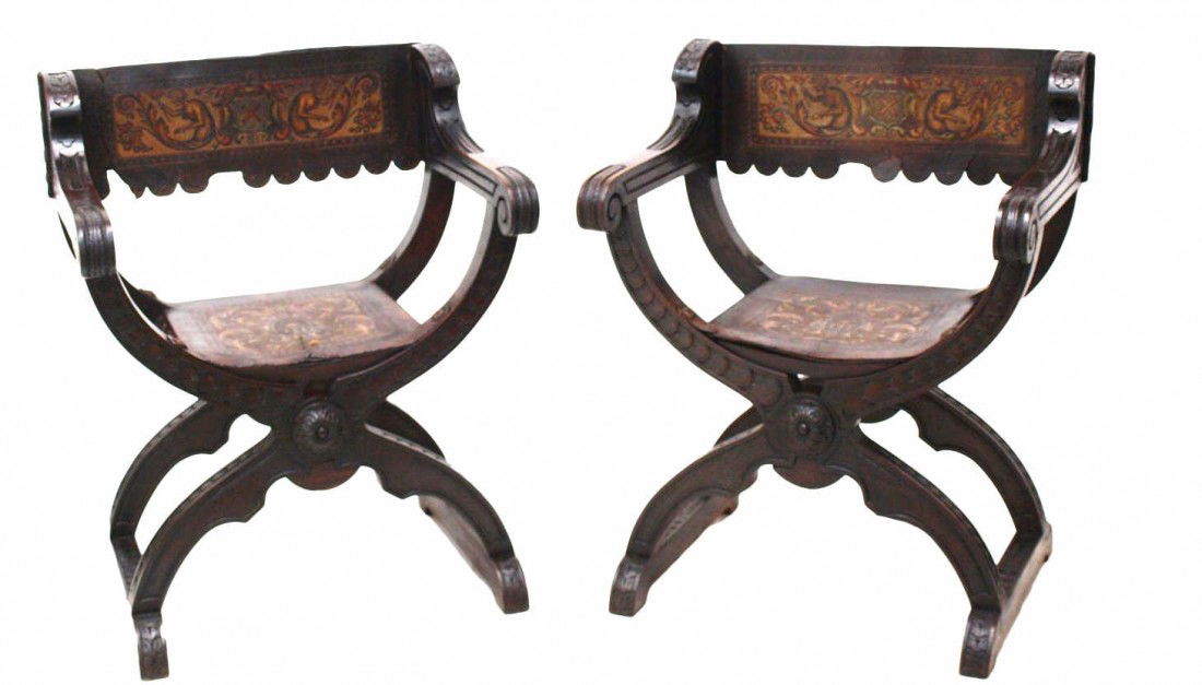 ANTIQUE SPAIN RENAISSANCE LEATHER X FORM CHAIRS: (pair) Renaissance style arm chairs of X-form, Spain, each having polychrome embossed leather back and seat decorated with demi-figures and foliates, leather with tears/restoration. 35.25"h, 25"w, 20"
