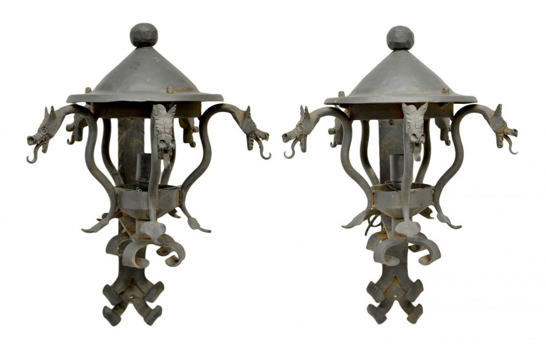 ANTIQUE SPAIN WROUGHT IRON DRAGON LIGHT SCONCES: (pair) Heavy Spanish black wrought iron single-light sconces in the manner of Antonio Gaudi (Spain, 1852-1926), early 20th c., four dragon figures support the cover with ball form finial, approx 27"h,