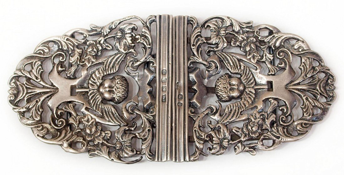 ANTIQUE BIRMINGHAM STERLING BUCKLE, C. 1898: English sterling silver buckle, Birmingham, in two-parts joined by hook, pierced openwork foliate motif centering a winged cherub mask, hallmarked with C.H, date letter for 1898, anchor, lion passant,