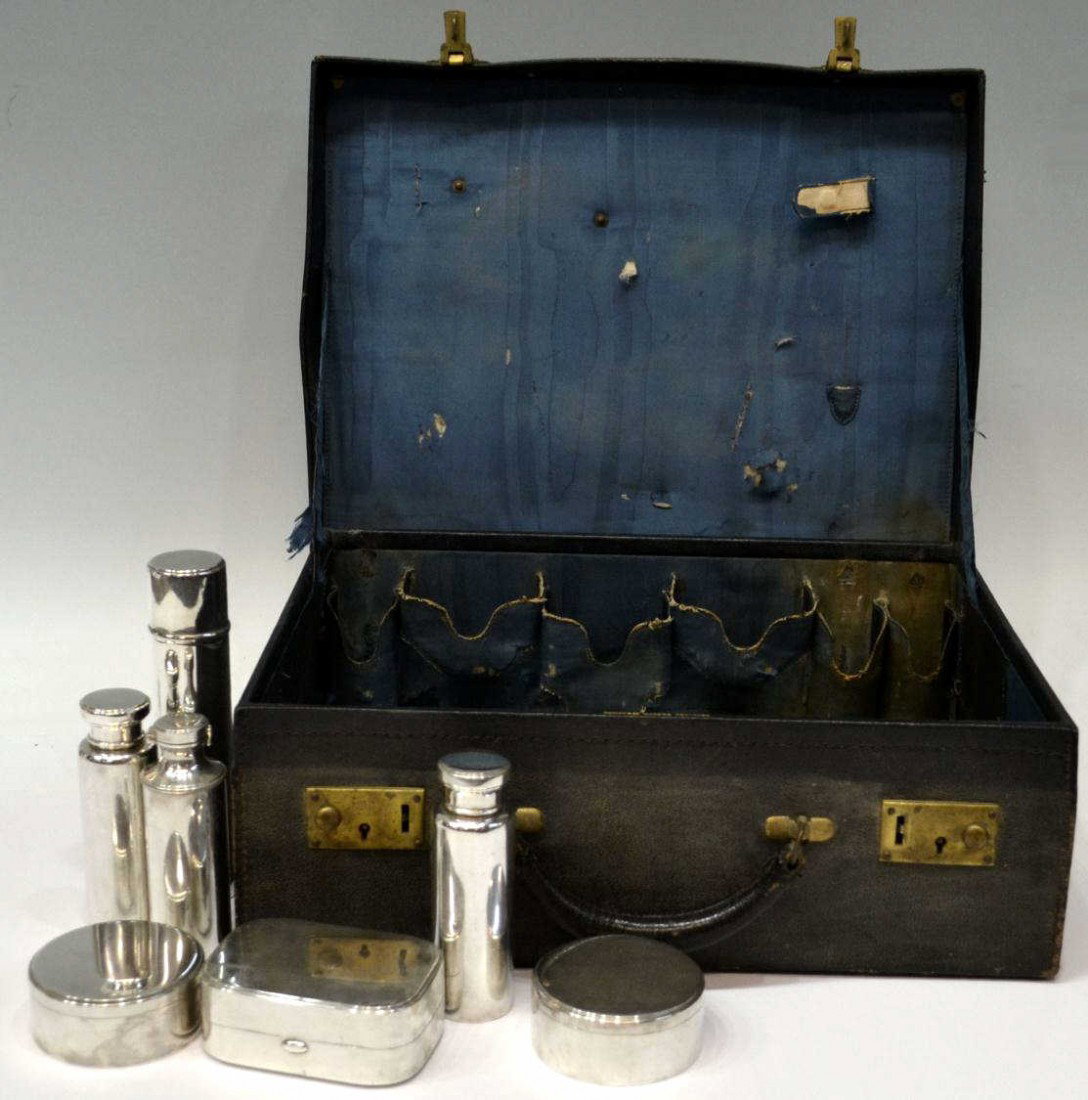 TIFFANY & CO. STERLING SILVER FITTED TRAVEL CASE: (lot of 8) A Tiffany & Company travel case, partially fitted with (4) varied bottles, (2) jars and (1) box, marks indicate 1907 ~ 1947, directorship of John C. Moore II, very worn case marked Tiffany 