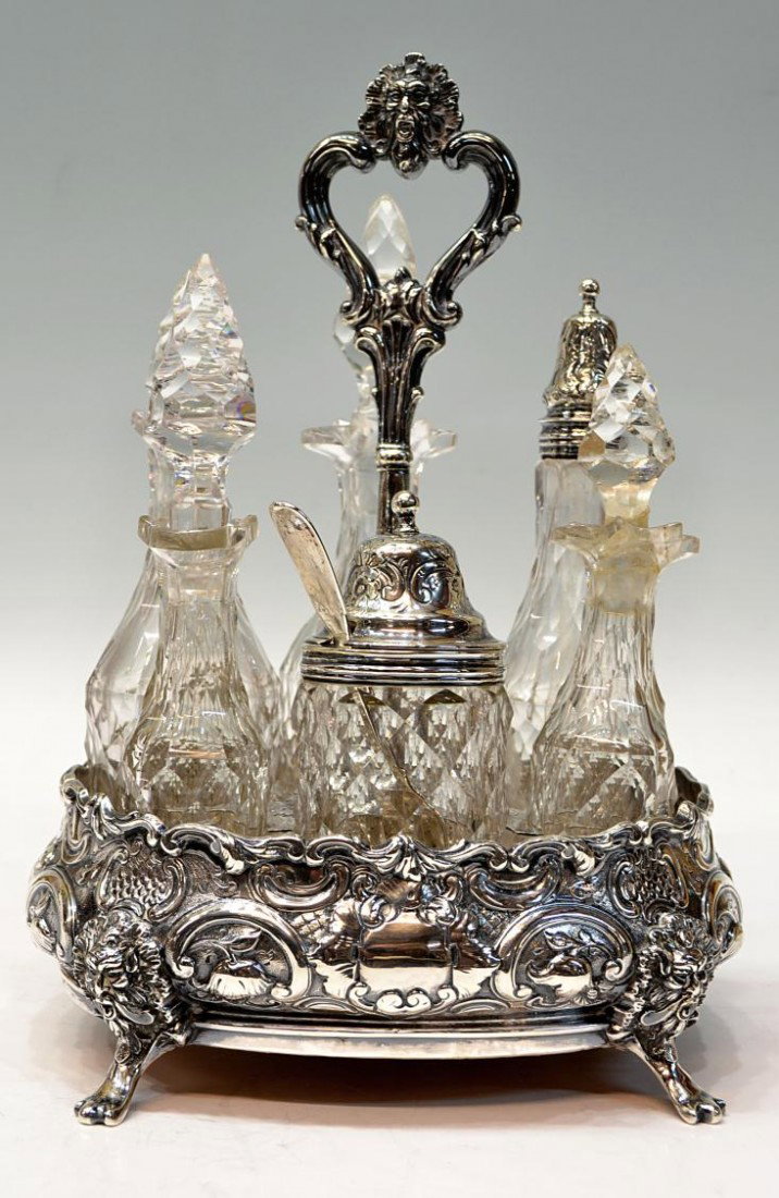 19TH C. WILLIAM R SMILY STERLING SILVER CASTOR SET: English sterling silver castor set, William Robert Smily, London, c. 1851, the repousse frame with profuse foliated scroll motif and engraved initials 'GB', rising on four paw feet surmounted by figur