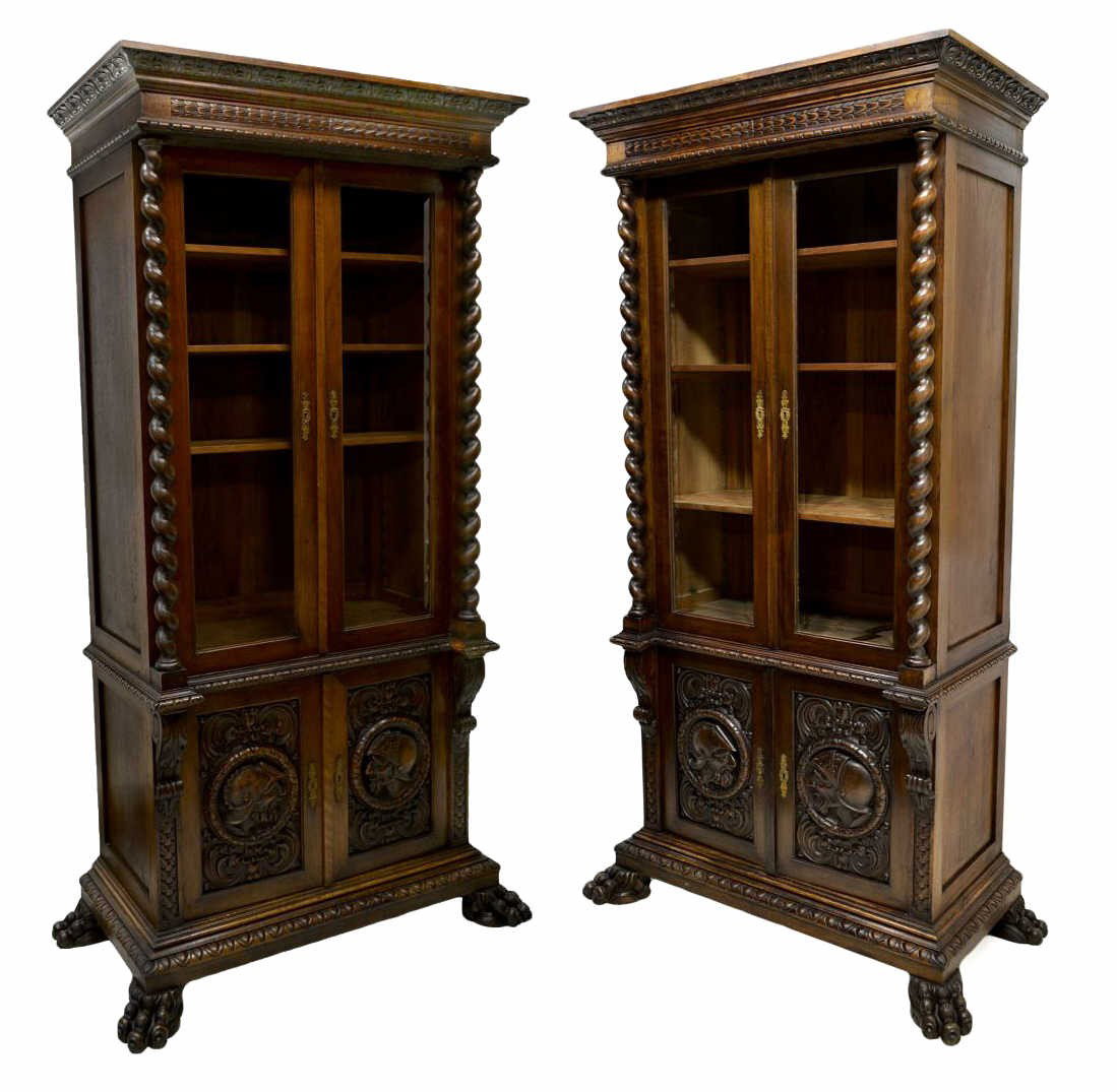 (PAIR) ANTIQUE SPANISH CARVED BOOKCASES: (pair) Spanish bookcases, Barcelona, c. 1900, each having a stepped foliate decorated cornice over two glazed doors opening to interior shelves and flanked by twist columns, the lower cabinet with two