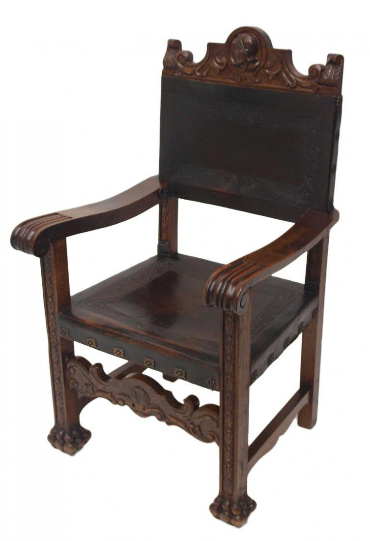 ANTIQUE SPANISH ARM CHAIR, LEATHER UPHOLSTERY: Antique Spanish arm chair, c. 1900, having a figural crest rail, leather back and seat, straight scroll end arms, square legs with foliate carving at front, resting on double paw feet, 45"h, 26.25"w, 