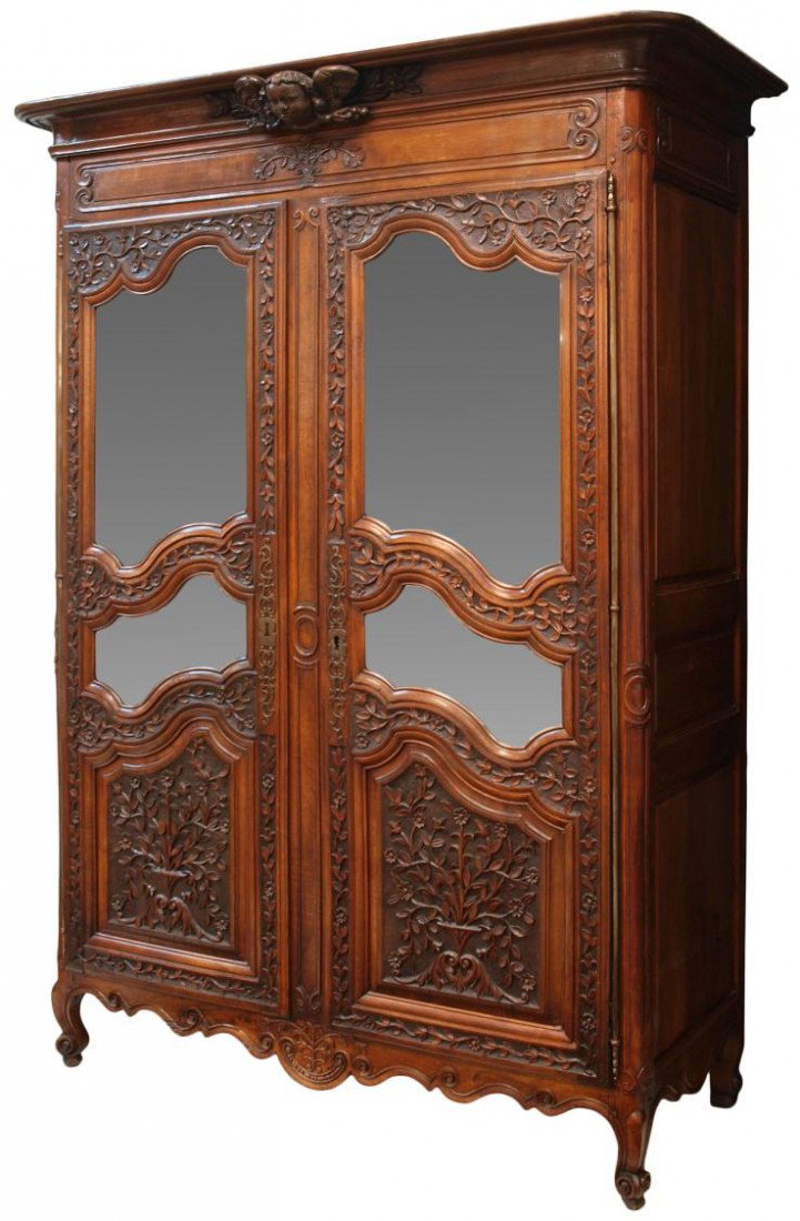 FINE RELIEF CARVED LOUIS XV ARMOIRE, C. 1790: French Louis XV armoire cabinet, c. 1790, a stepped cornice with protruding central winged putto over two paneled doors hung on full length brass hinges, each door with relief carved foliate and flora